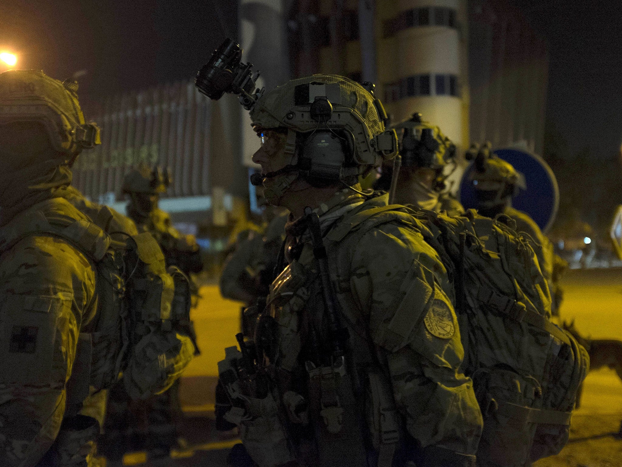 French and US soldiers gather before launching a counter-assault on Islamist gunmen at the Splendid Hotel in Ouagadougou, Burkina Faso, January 16, 2016.