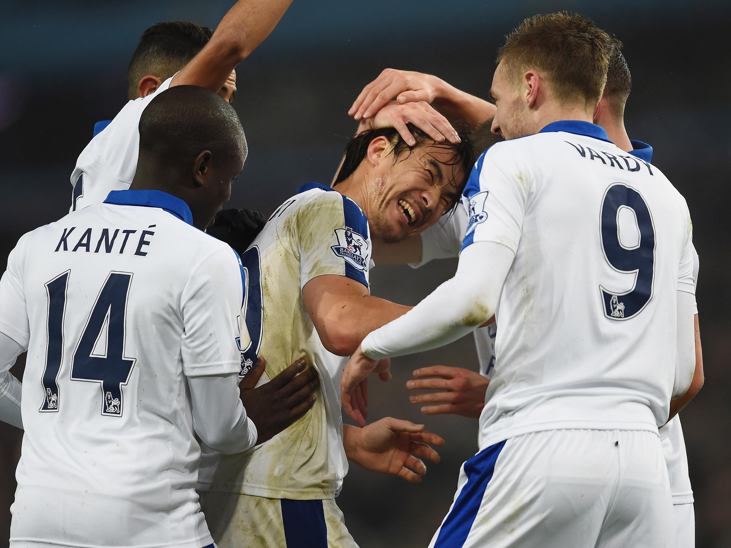 Shinji Okazaki is congratulated on his opening goal