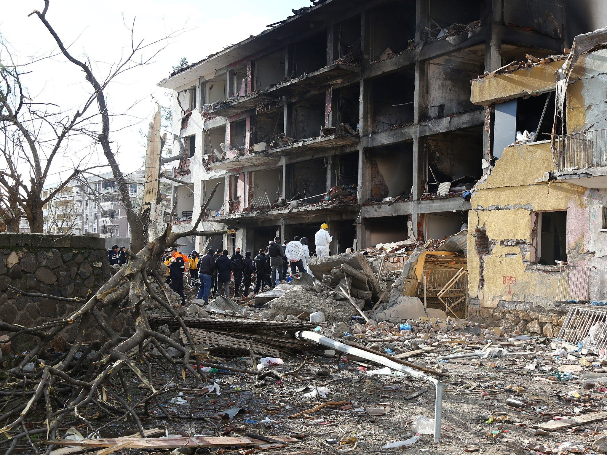 Investigators search the scene of the last week’s bomb blast at the police lodgings in Cinar, south of Diyarbakir city