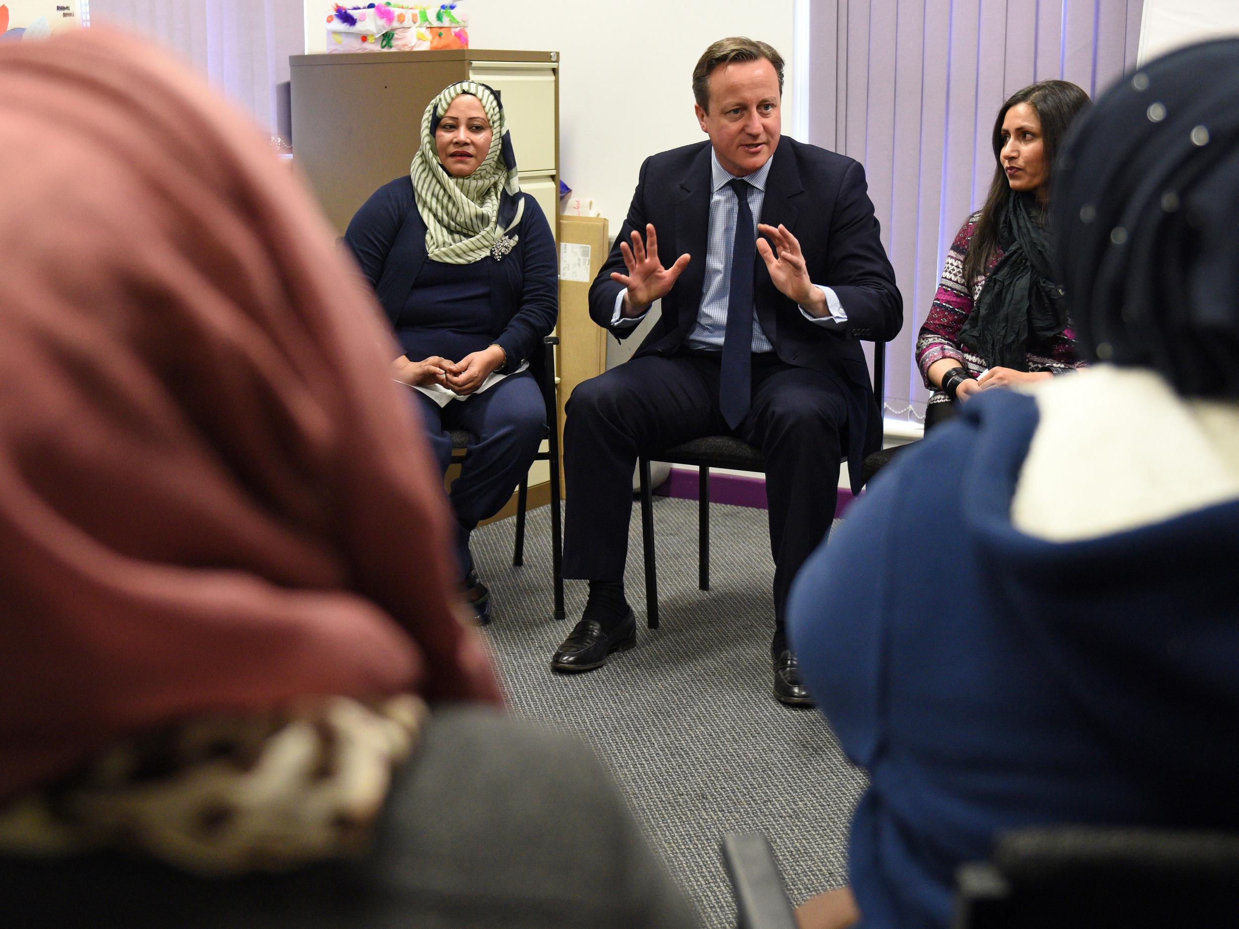 David Cameron speaks with women attending an English language class during a visit to the Shantona Women's Centre in Leeds Getty