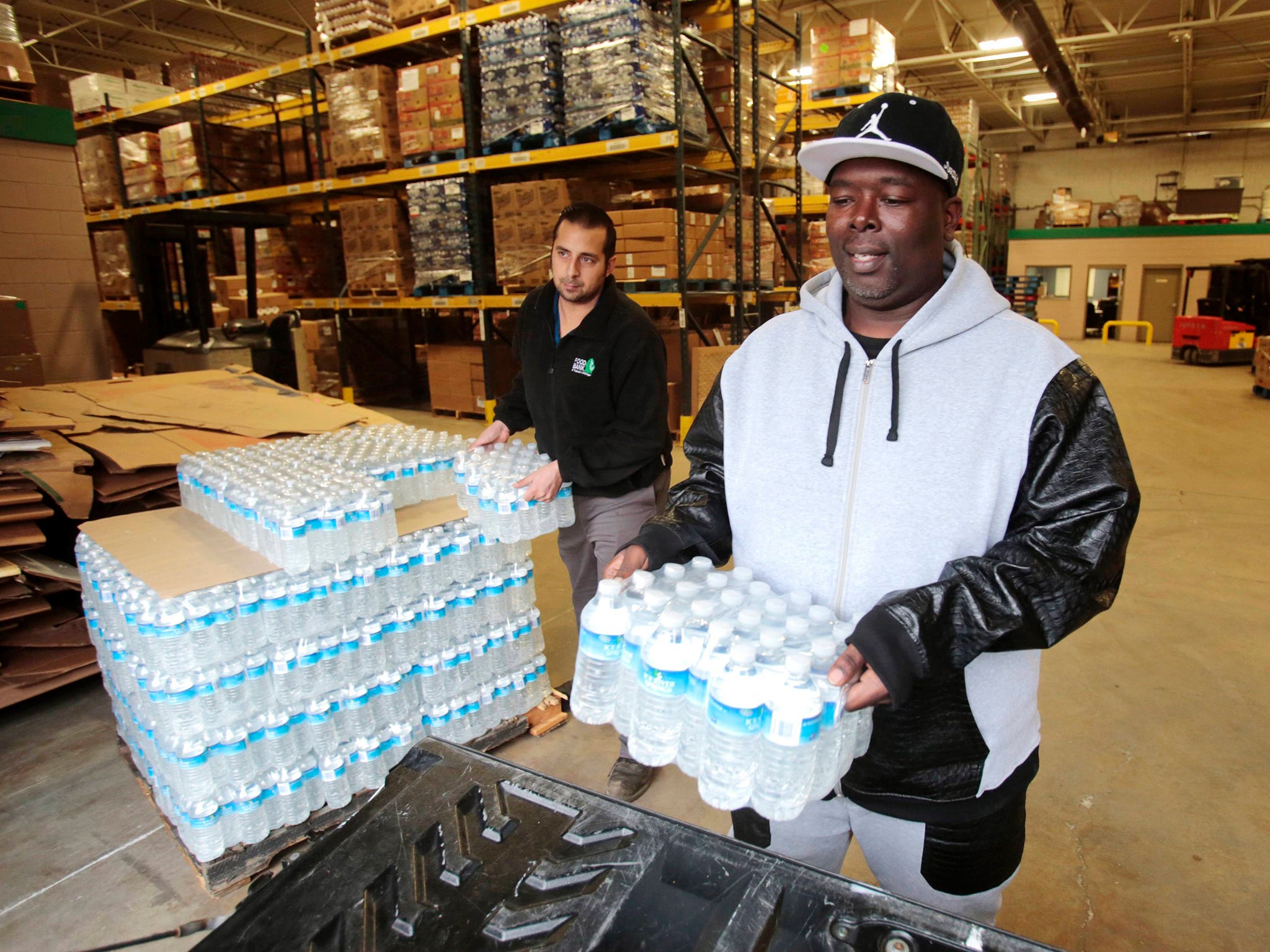 Anthony Fordham picks up bottled water from the Food Bank of Eastern Michigan to deliver to a school after elevated lead levels were found in the city's water in Flint