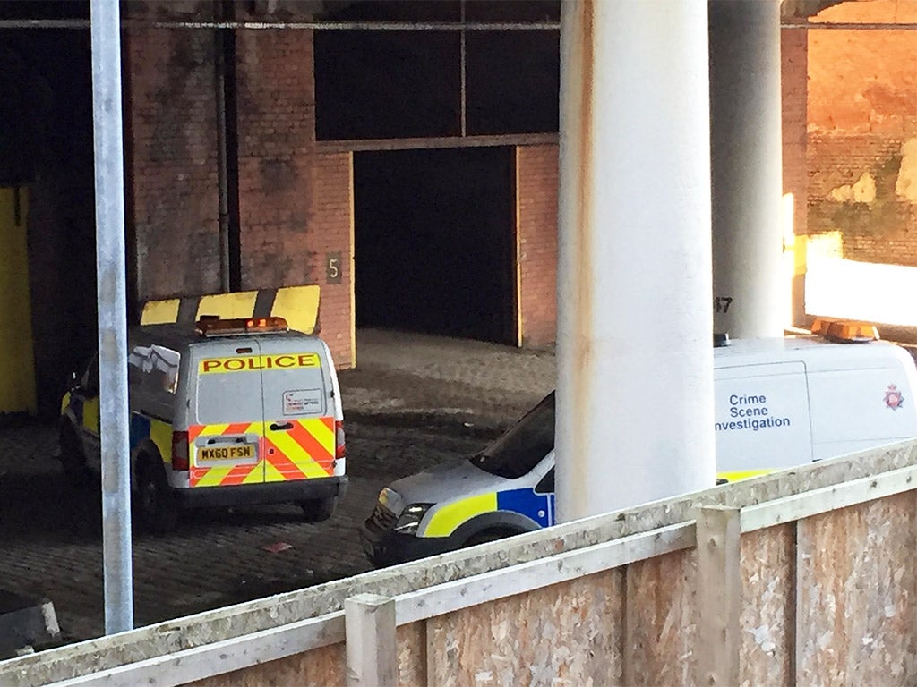 Police cars close to the scene underneath a railway bridge in Salford, Greater Manchester