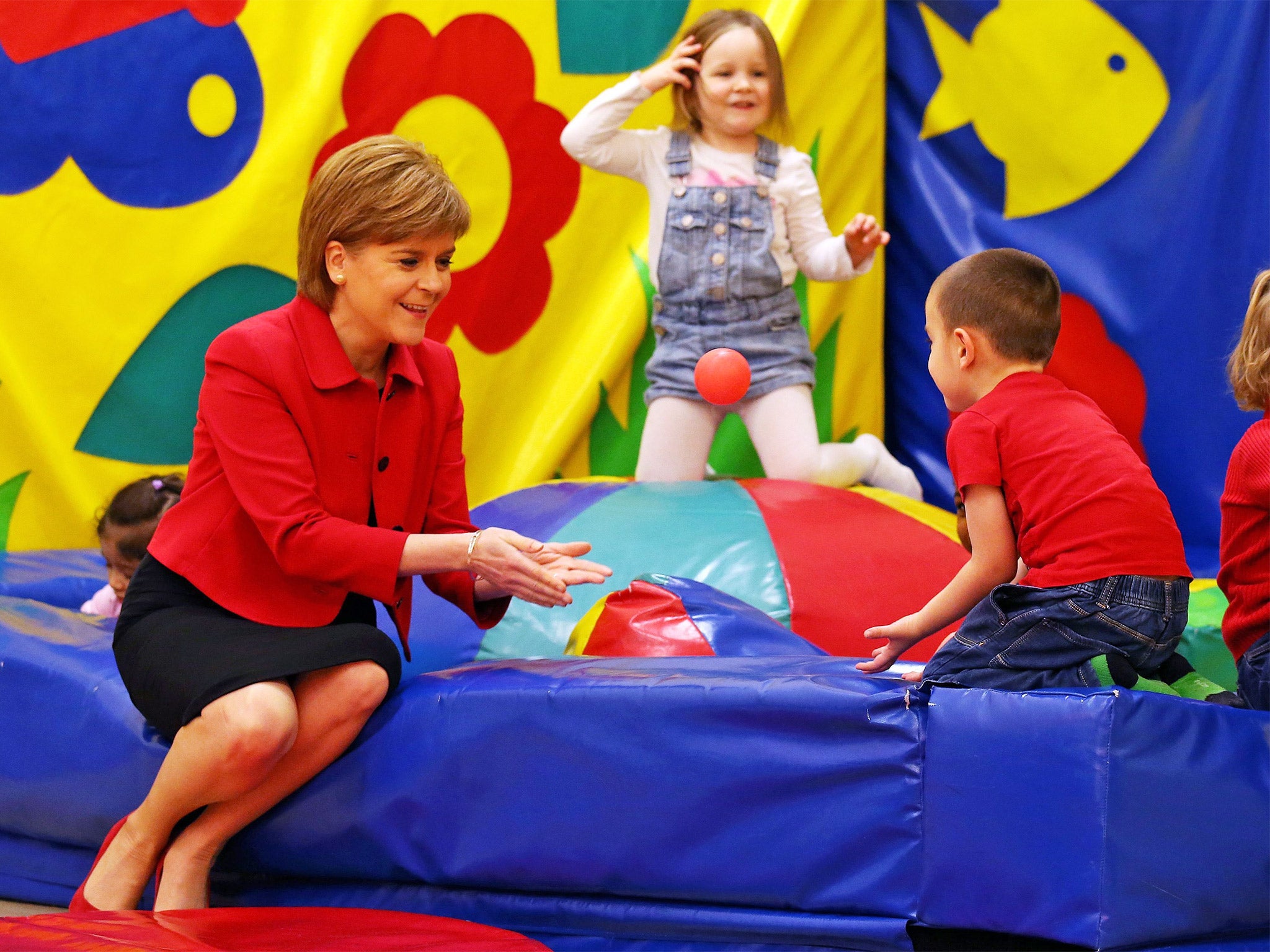 First Minister Nicola Sturgeon plays with children during a visit to a childcare charity in Edinburgh on Wednesday