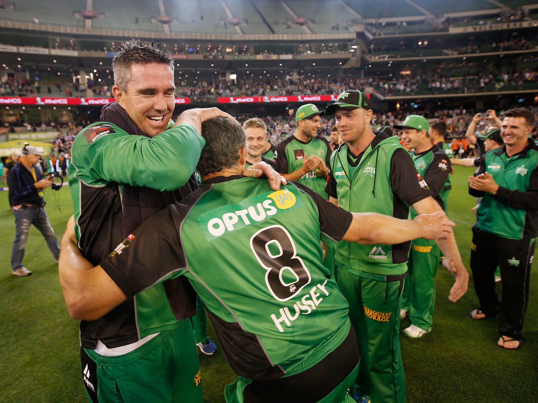 Kevin Pietersen and David Hussey of the Melbourne Stars embrace after winning the Big Bash League Semi Final match against the Perth Scorchers at Melbourne Cricket Ground.