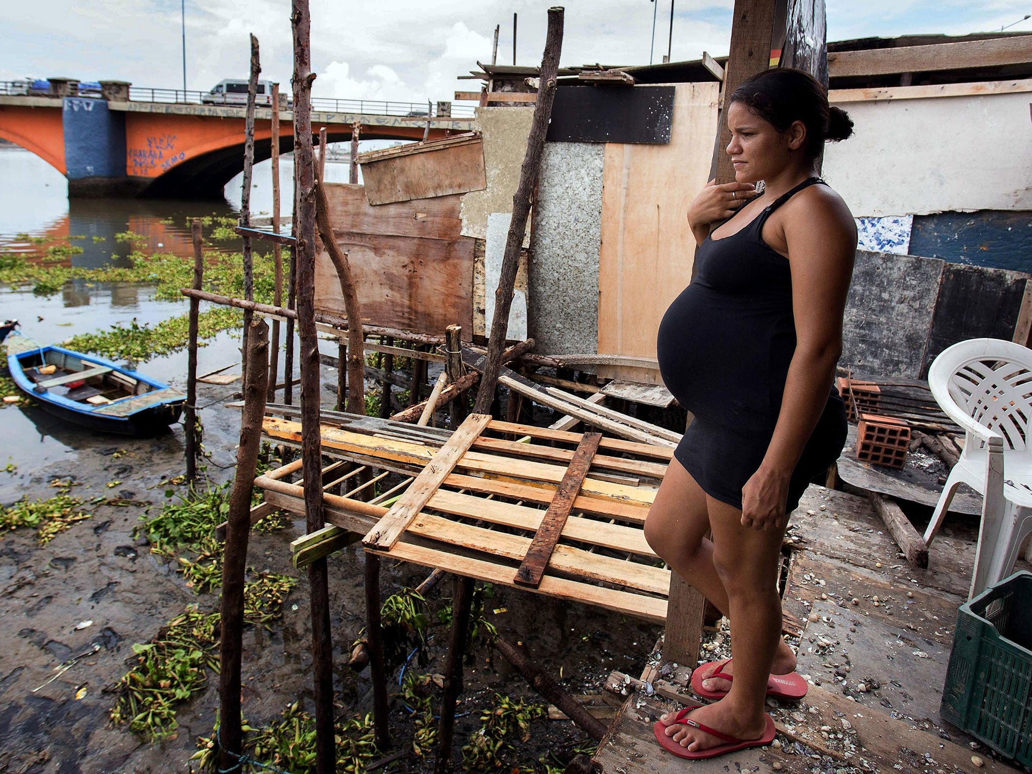 A pregnant woman stands at her house in a zone of the shanty town of Beco do Sururu in Brazil