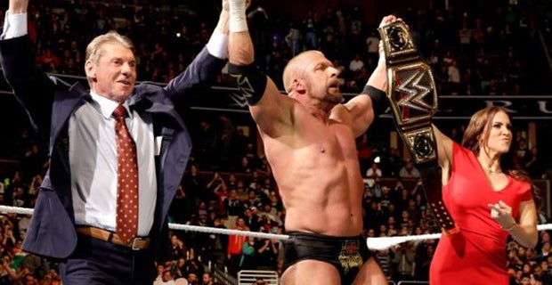 Triple H celebrates his win with Vince McMahon and Stephanie McMahon