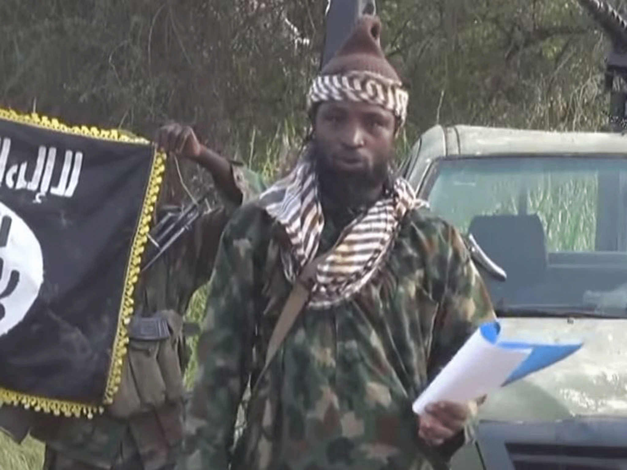 Abubakar Shekau, current leader of Boko Haram, speaking from a script to declare allegiance to Isis in October 2014