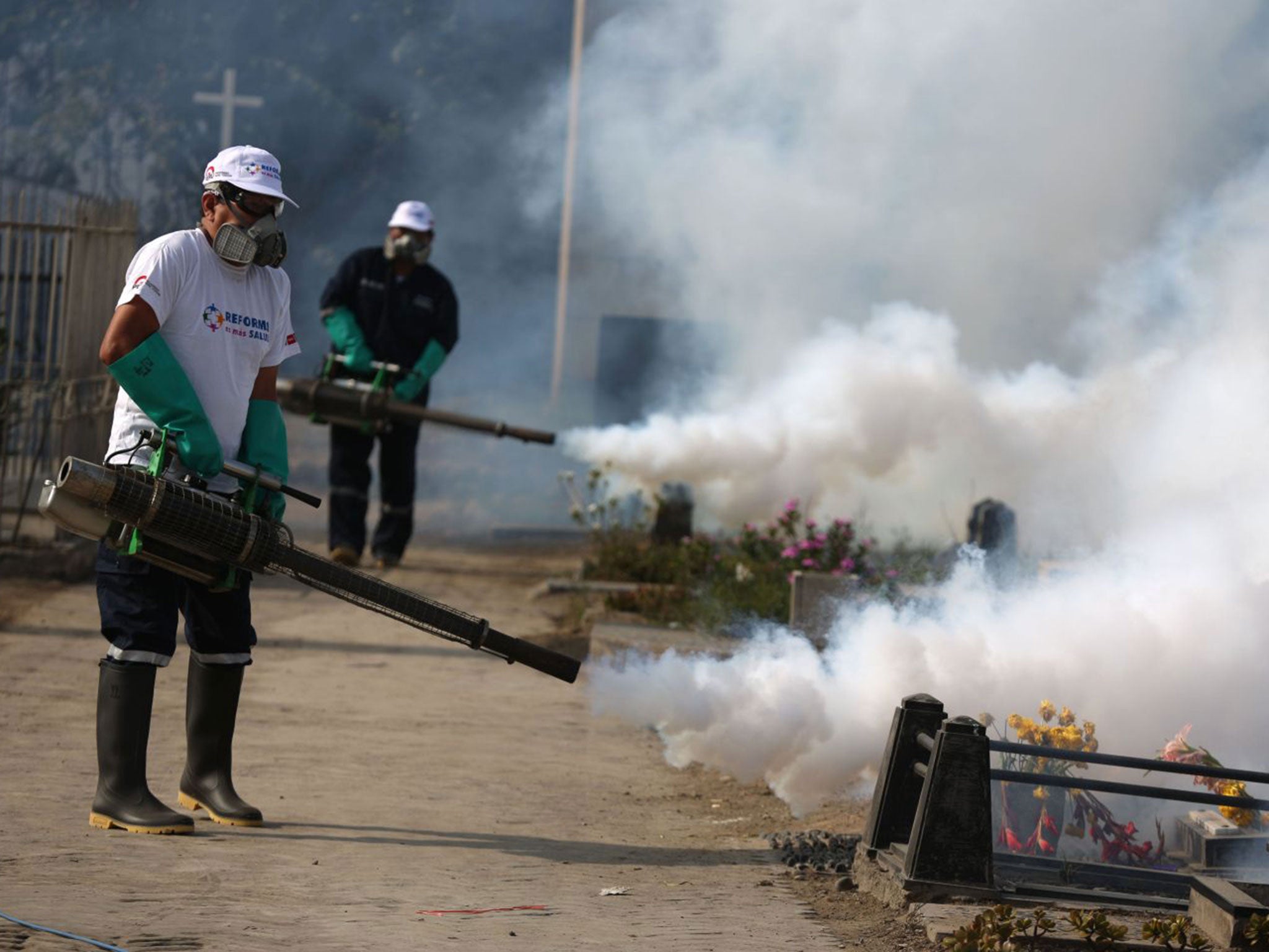 Health workers fumigating to combat Zika virus in Lima, Peru. The US have already issued a warning urging pregnant women to avoid travel to Latin American countries