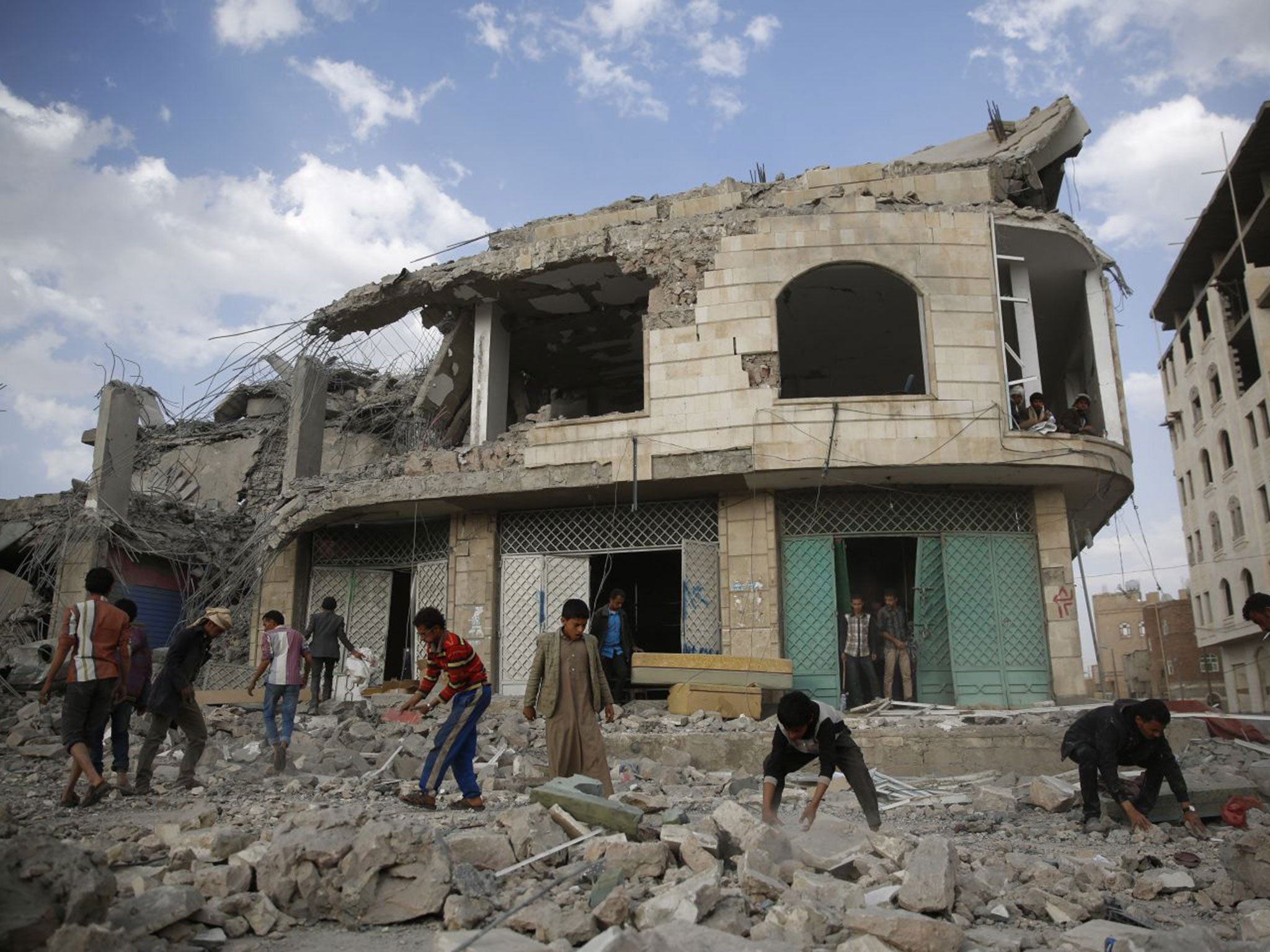 People inspect the rubble of a house destroyed by a Saudi-led airstrike in Sanaa, Yemen. The missile fired by the Saudi-led coalition killed eight people