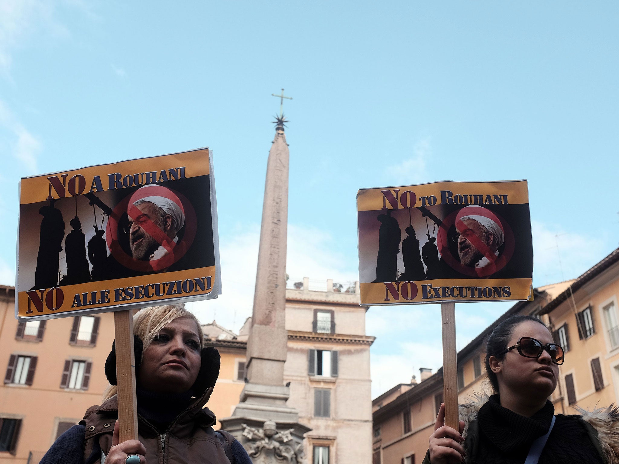 Demonstrators protest against Iranian President Hassan Rouhani 's visit in front of the pantheon on January 26, 2016