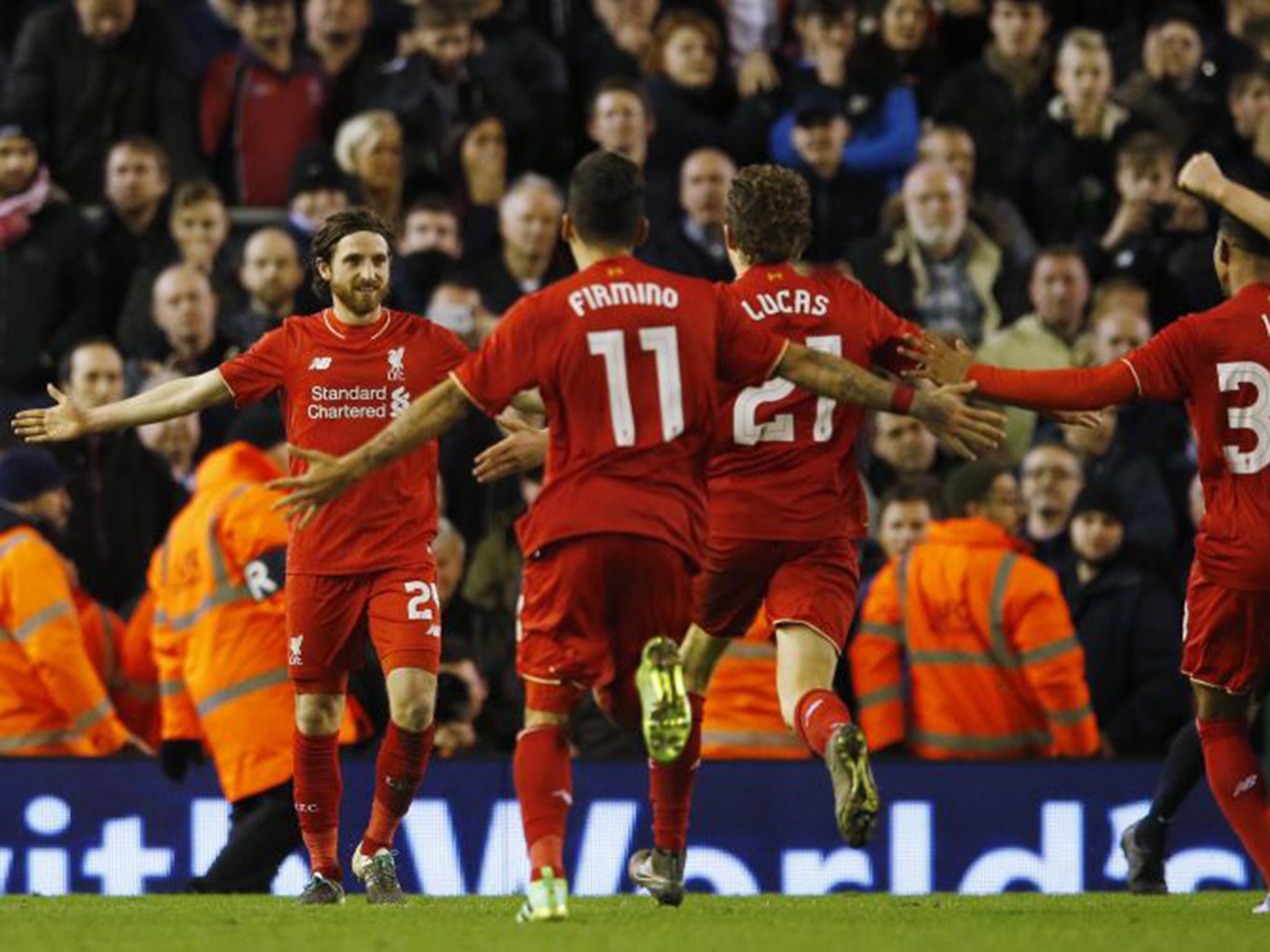 Liverpool players celebrate after Joe Allen's winning penalty