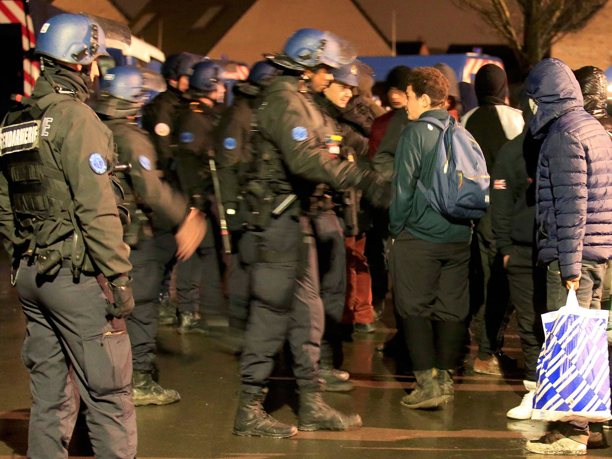 French gendarmes control migrants near the Grande-Synthe jungle of makeshift shelters, near Dunkirk, France