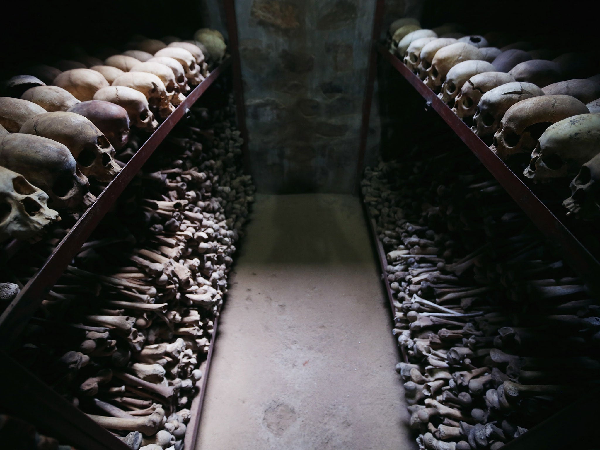 Metal racks hold the bones of thousands of Rwandan Genocide victims inside one of the crypts at the Nyamata Catholic Church memorial