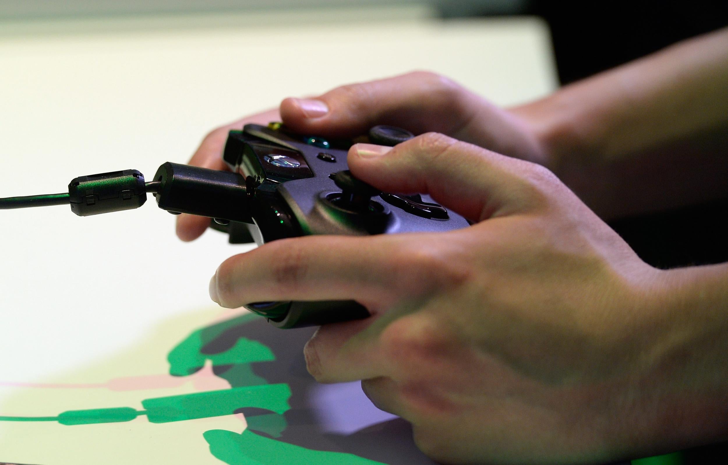 A man plays on the Xbox One at E3 2013