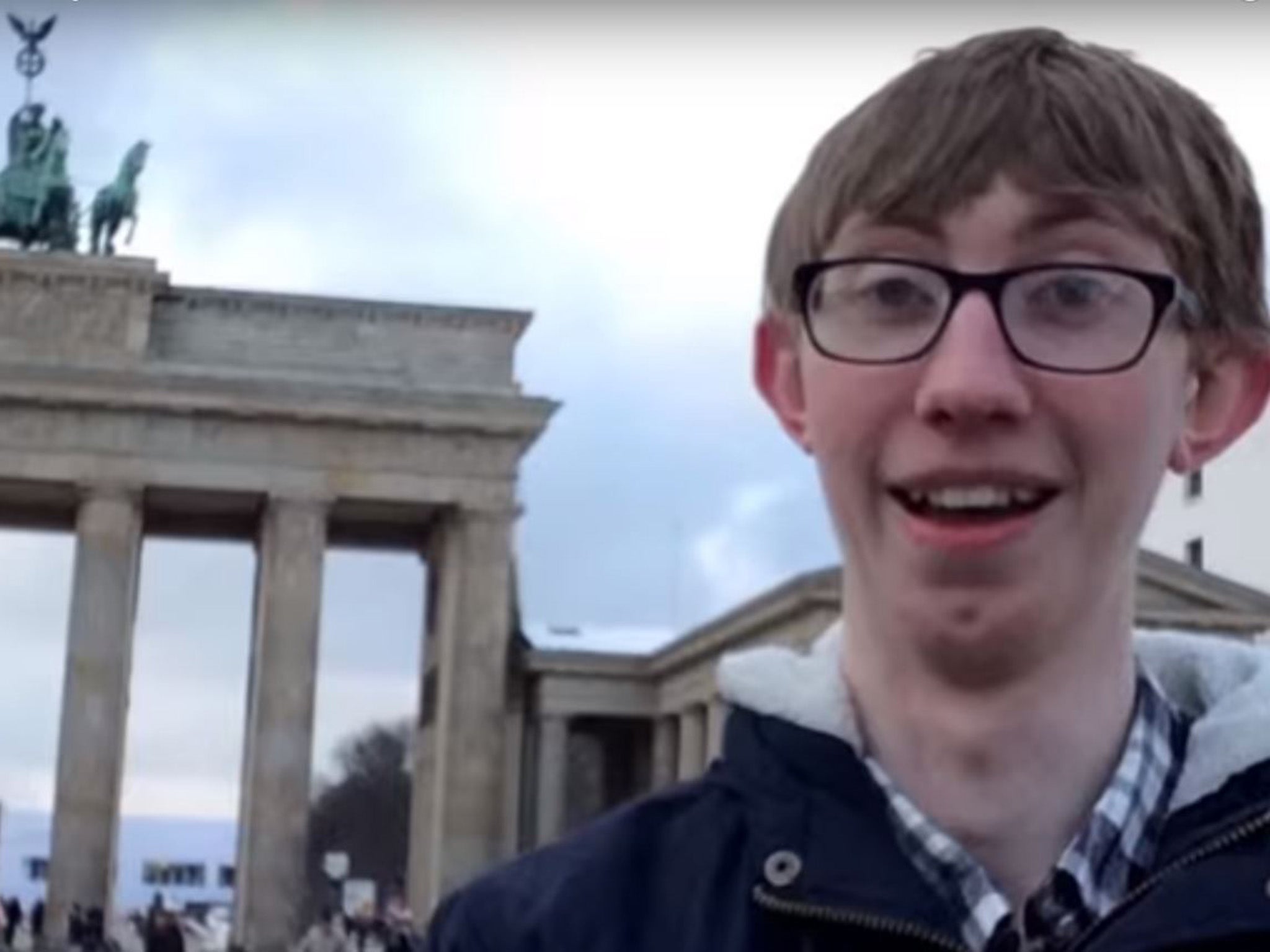 Jordan Cox outside the Brandenburg Gate in Berlin as he details how he saved money on his adventure