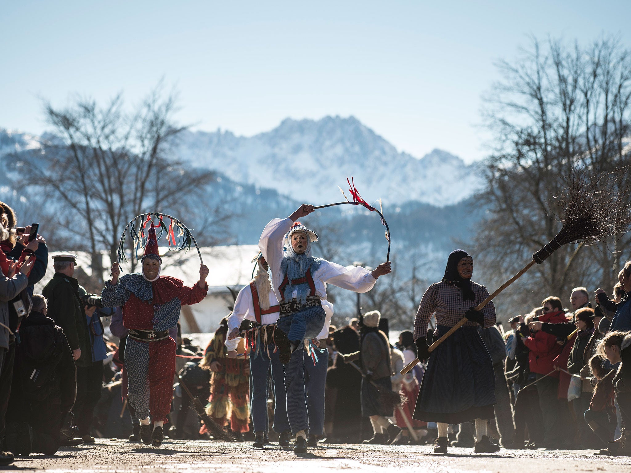 Costumed participants tossing a so called 'Jackel' perform in the annual carnival parade on February 12, 2015 in Mittenwald, Germany.