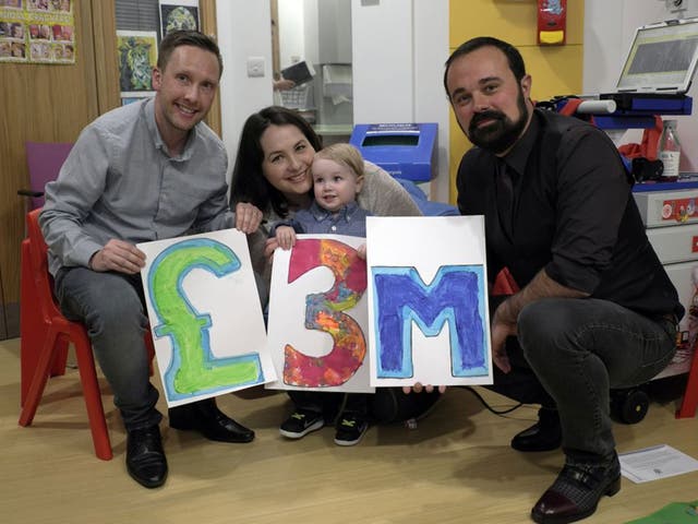 Elliott Livingstone, a patient at GOSH, and his parents, Adrian and Candace, celebrate with Evgeny Lebedev, owner of ‘The Independent’ (Jo