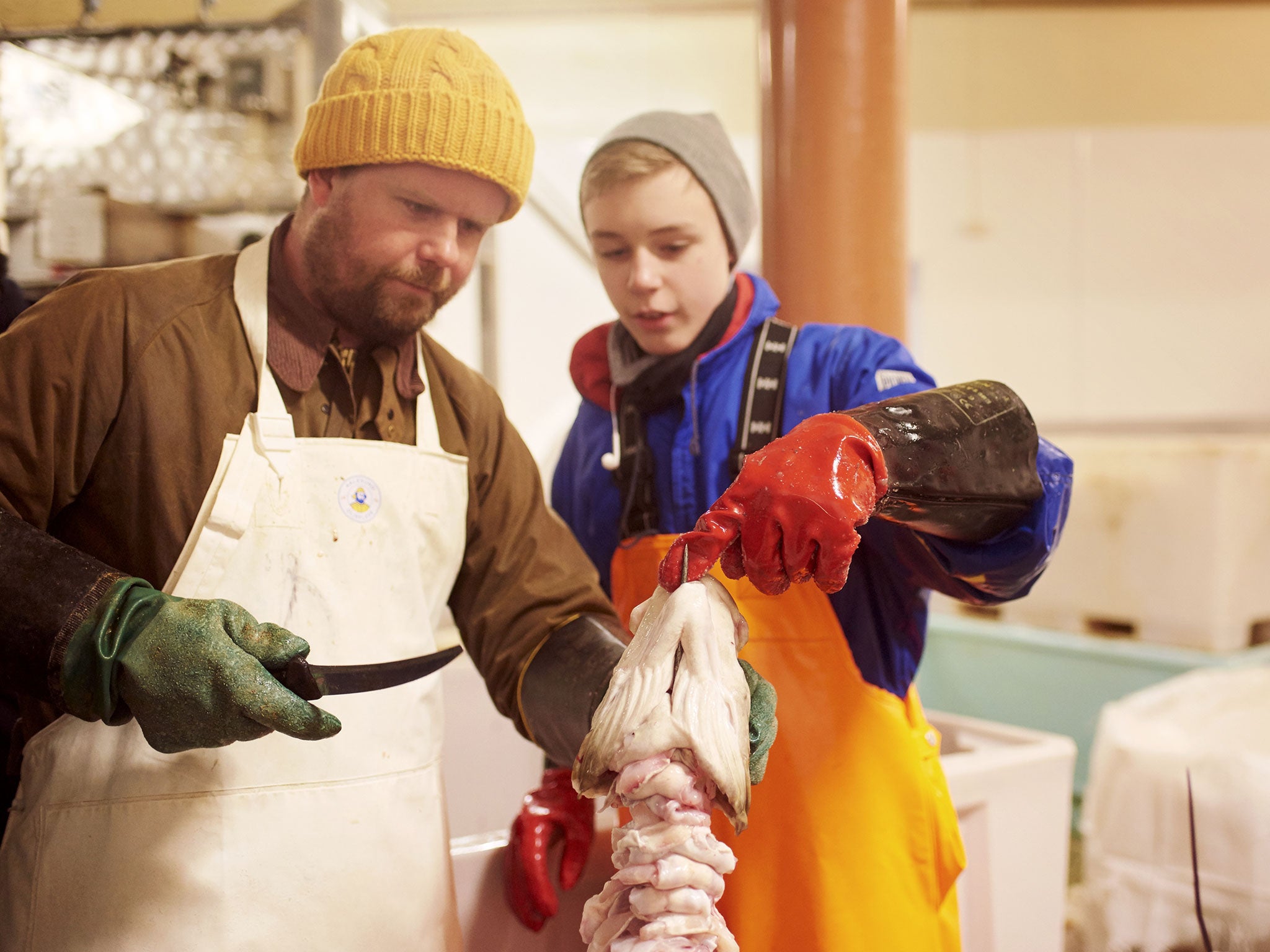 A local child shows Robin Gill how to cut out the tongue