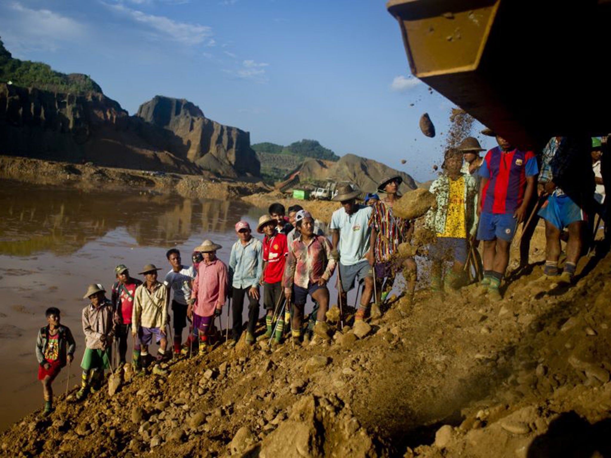 Villagers in Hpakant dig for jade fragments in rubble dumped by diggers