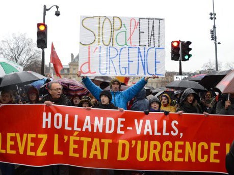 Thousands of protesters marched in the Paris rain to call on the French government to end the state of emergency