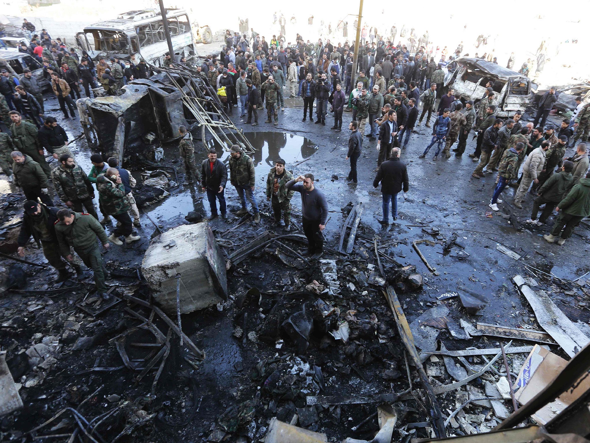 The aftermath of an Isis suicide bombing in which 60 people died near a Shia shrine in Sayyida Zeinab outside Damascus