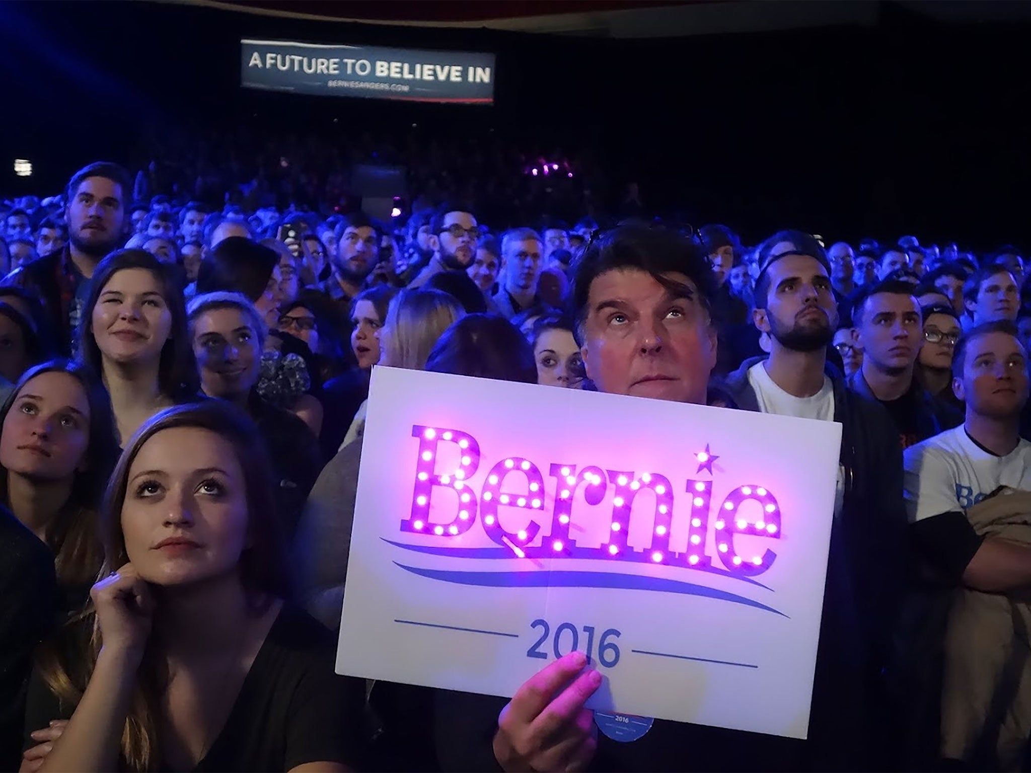 Supporters listen to Democrat Bernie Sanders addressing an event in Iowa City
