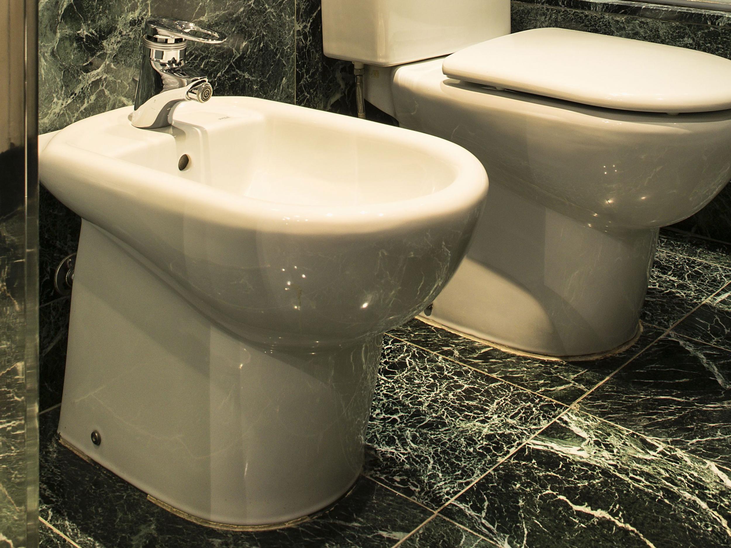 A man was arrested after he threw a bidet out of the window, hitting a father in the street below