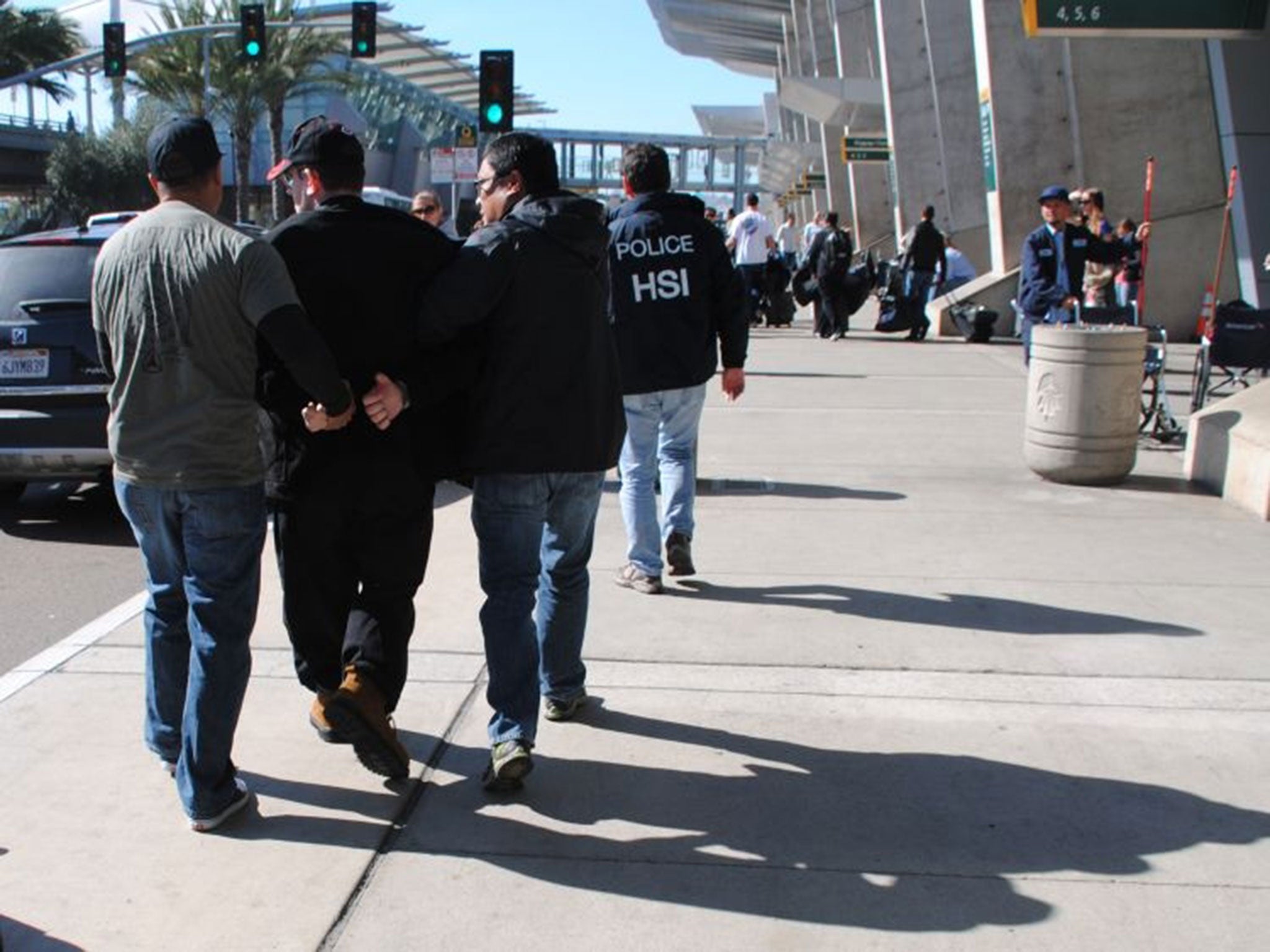 Joel Wright, second left, is arrested at San Diegoís airport in San Diego on federal charges for allegedly seeking to have sex with infant and young girls in Mexico.