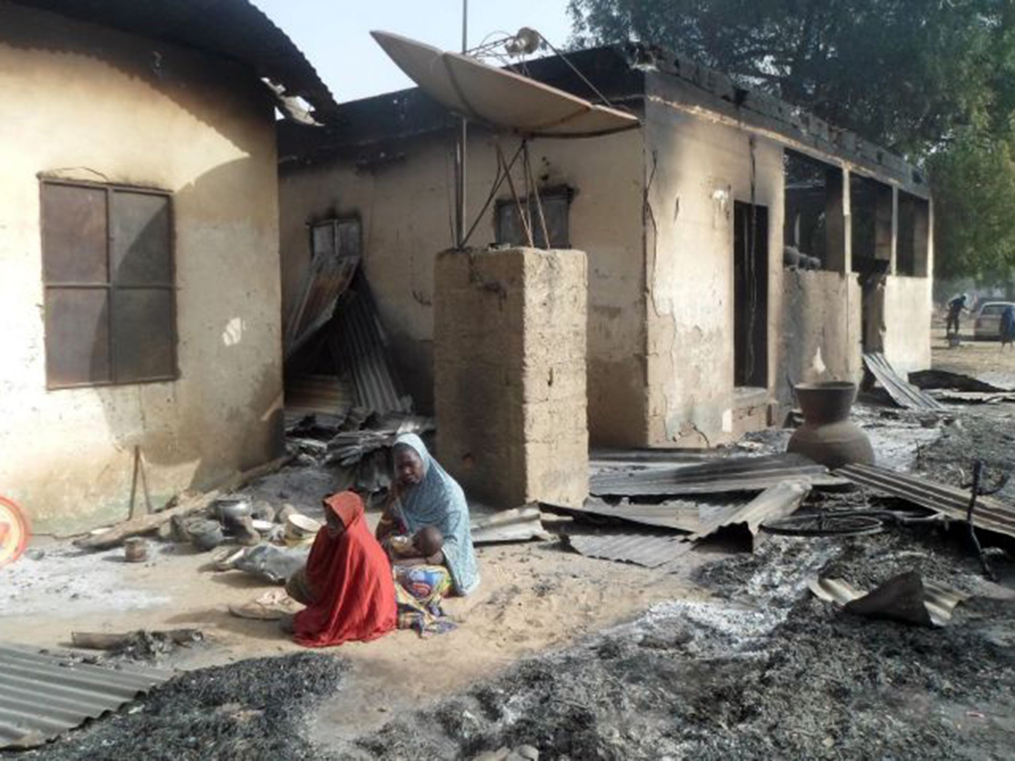 A mother mourns the death of her husband after Boko Haram attacked Dalori in Nigeria on Sunday