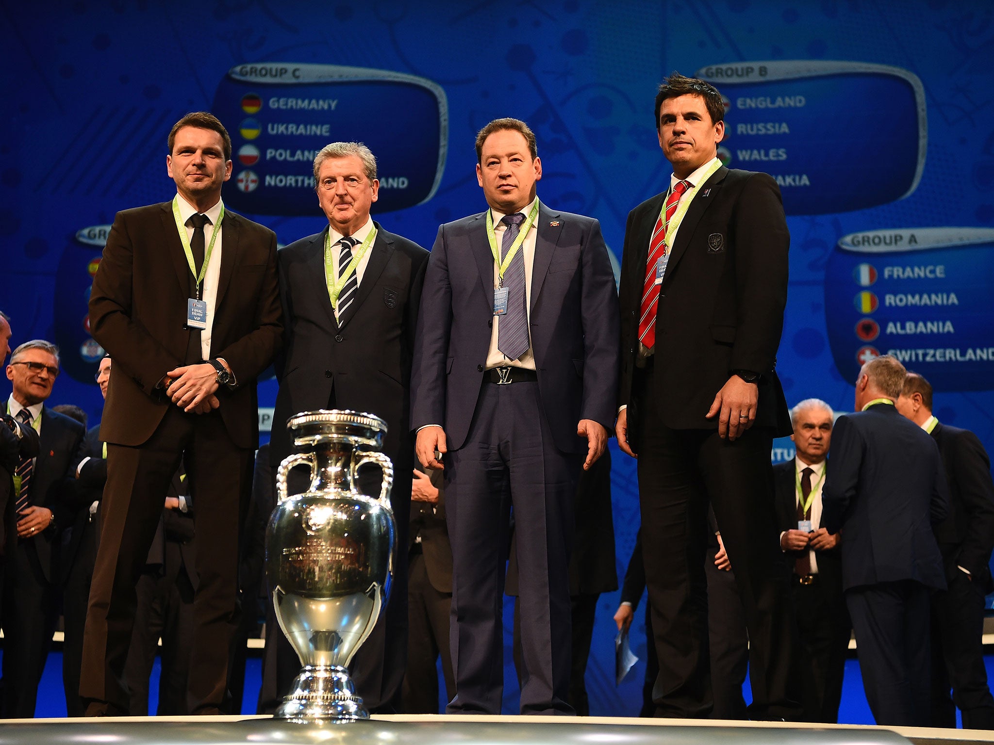 The managers of Slovenia, England, Russia and Wales stand behind the European Championship trophy