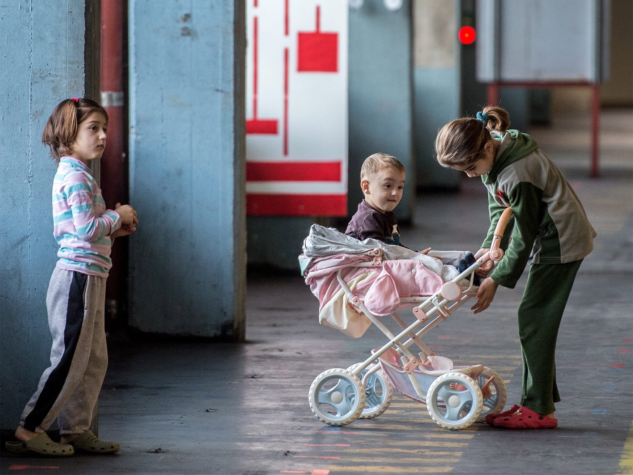 Children play in a building converted into refugee accommodation in Frankfurt