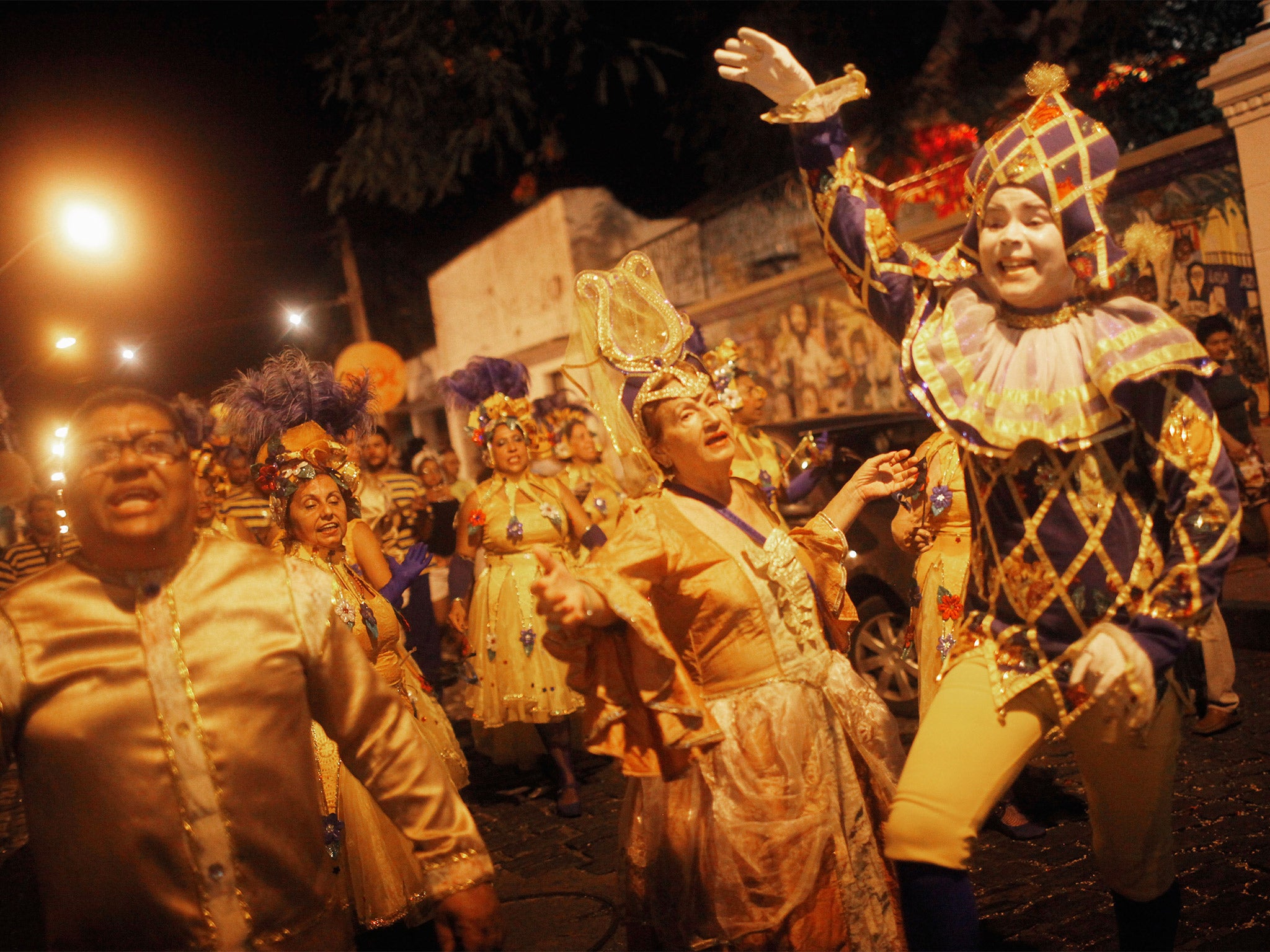 Revellers march during pre-Carnival celebrations in Olinda, Brazil, but many more events have been cancelled