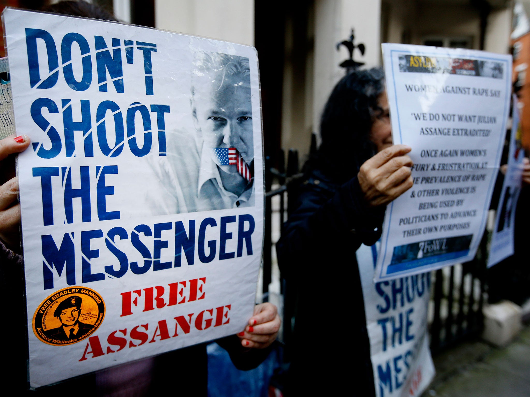 Demonstrators hold banners outside the Ecuadorean Embassy in London, where Wikileaks founder Julian Assange is staying