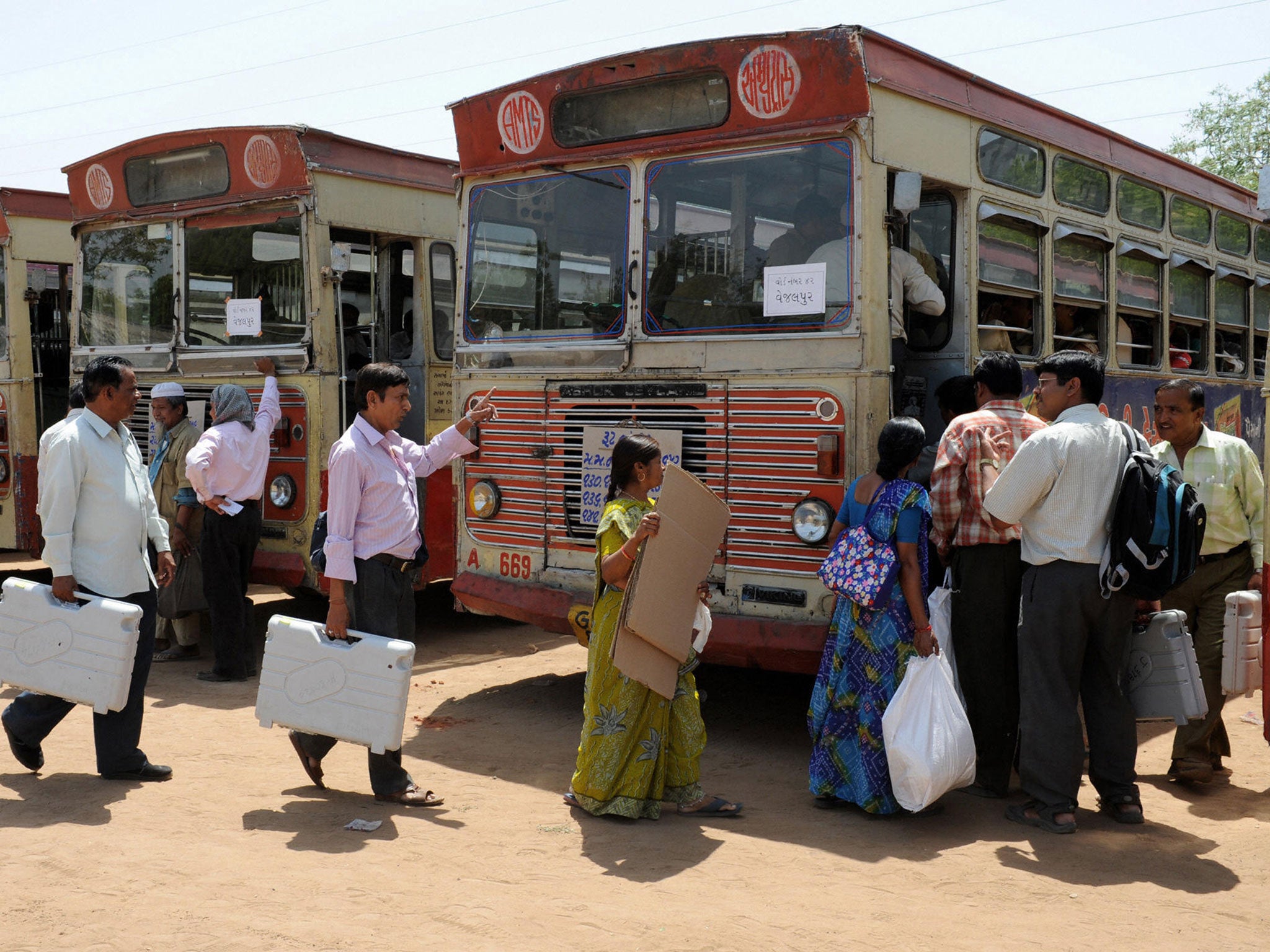 Indian officials carry Electronic Voting Machines