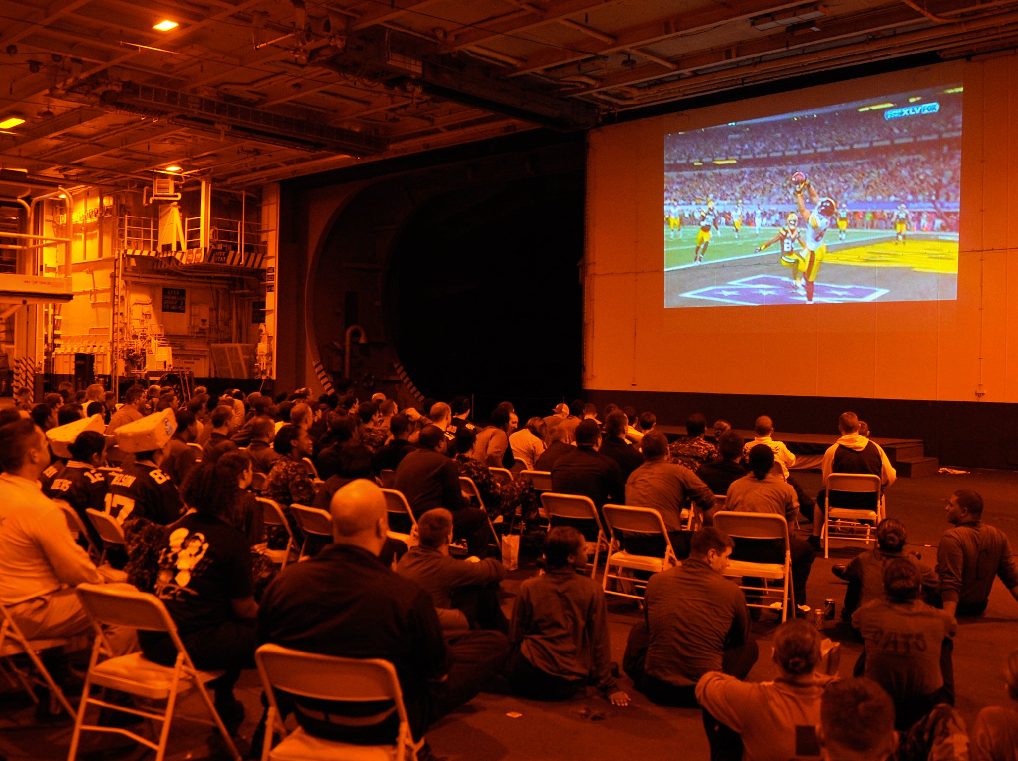 U.S. sailors watch NFL's Super Bowl XLV football game between the Pittsburgh Steelers and the Green Bay Packers, aboard the USS Harry S. Truman aircraft carrier in an undisclosed location February 6, 2011