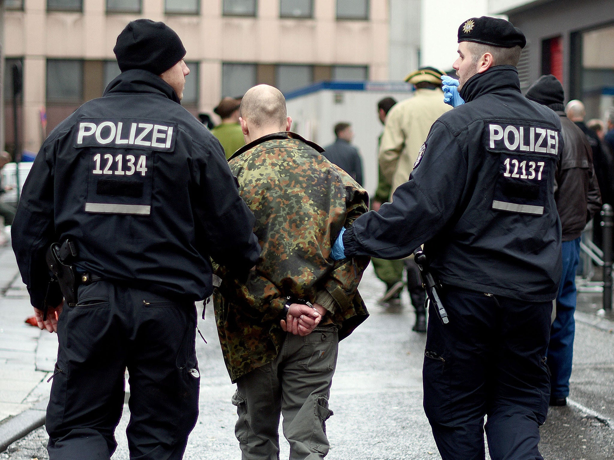 Police detain a man during the celebrations in Cologne