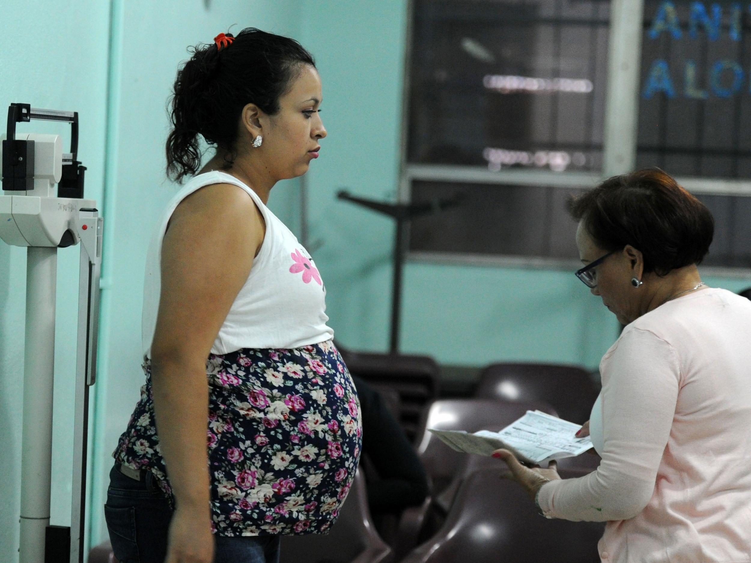 A pregnant woman is checked by a doctor at the 'Alonso Suazo' clinic in Tegucigalpa