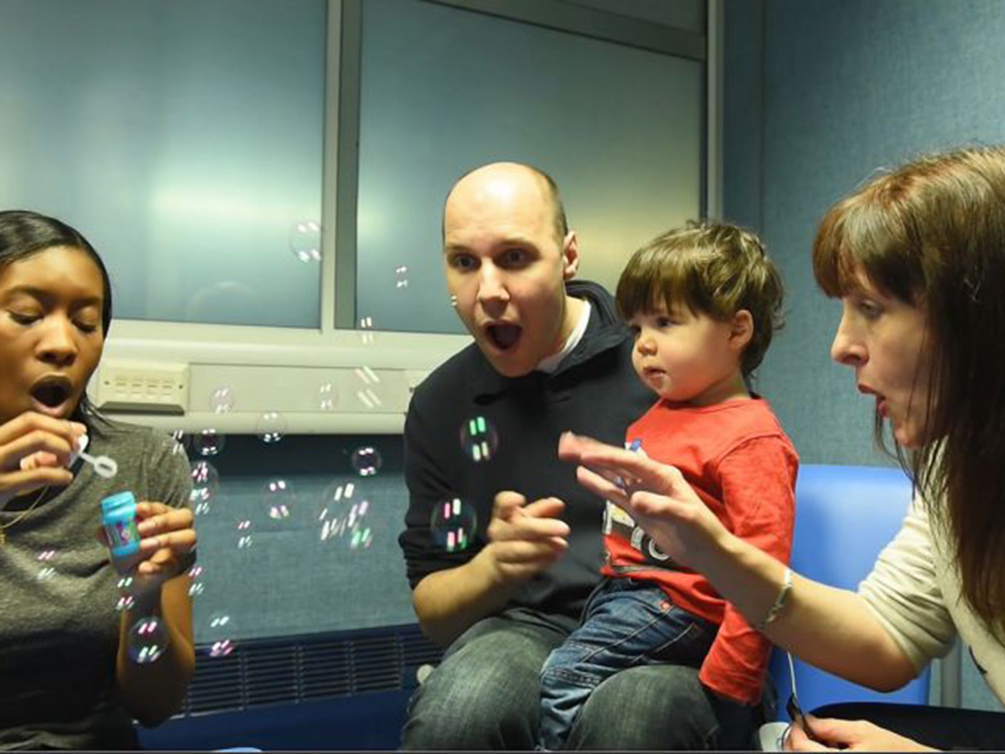 Alfie Morgan-Connolly, who was born with virtually no hearing, delights at the sight of a shower of blown bubbles