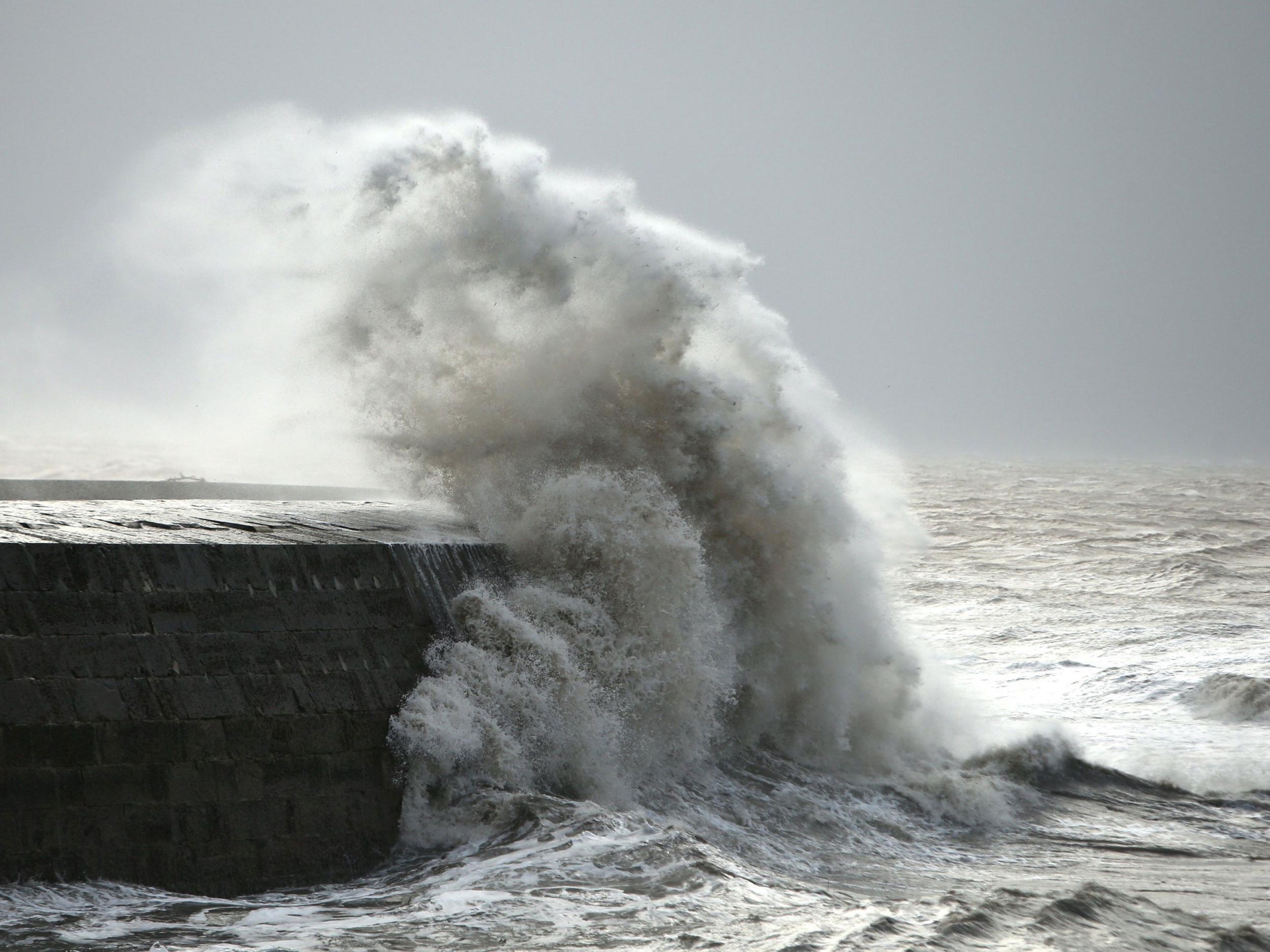 Waves crash against the harbour wall in Lyme Regis, Dorset as winds of nearly 100mph battered Britain after Storm Imogen slammed into the south coast PA