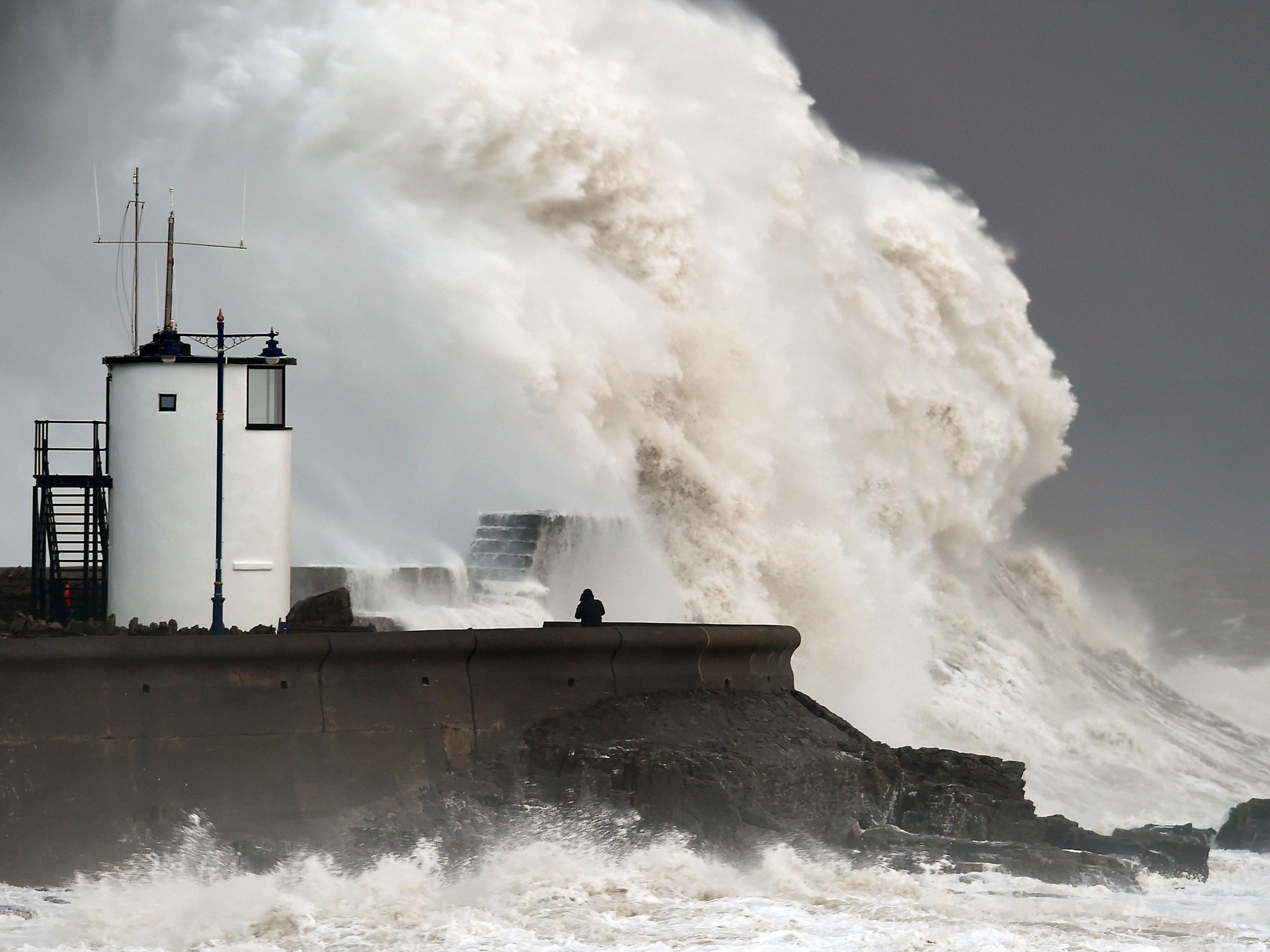 Waves crash over the sea wall at Porthcawl in Wales as winds of nearly 100mph battered Britain after Storm Imogen slammed into the south coast bringing fierce gusts and torrential downpours