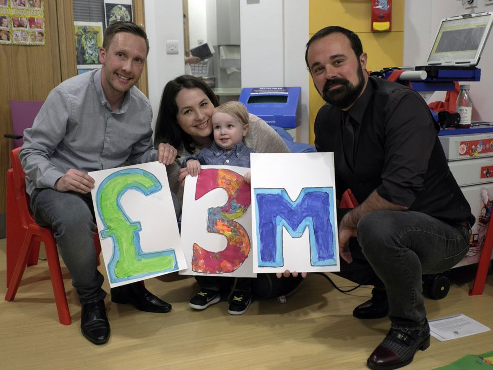 Two-year-old Elliot Livingstone, who is being treated at GOSH while he waits for a heart transplant, and his parents, Adrian and Candace, celebrate £3 million being raised with Evgeny Lebedev, the owner of The Independent and Evening Standard