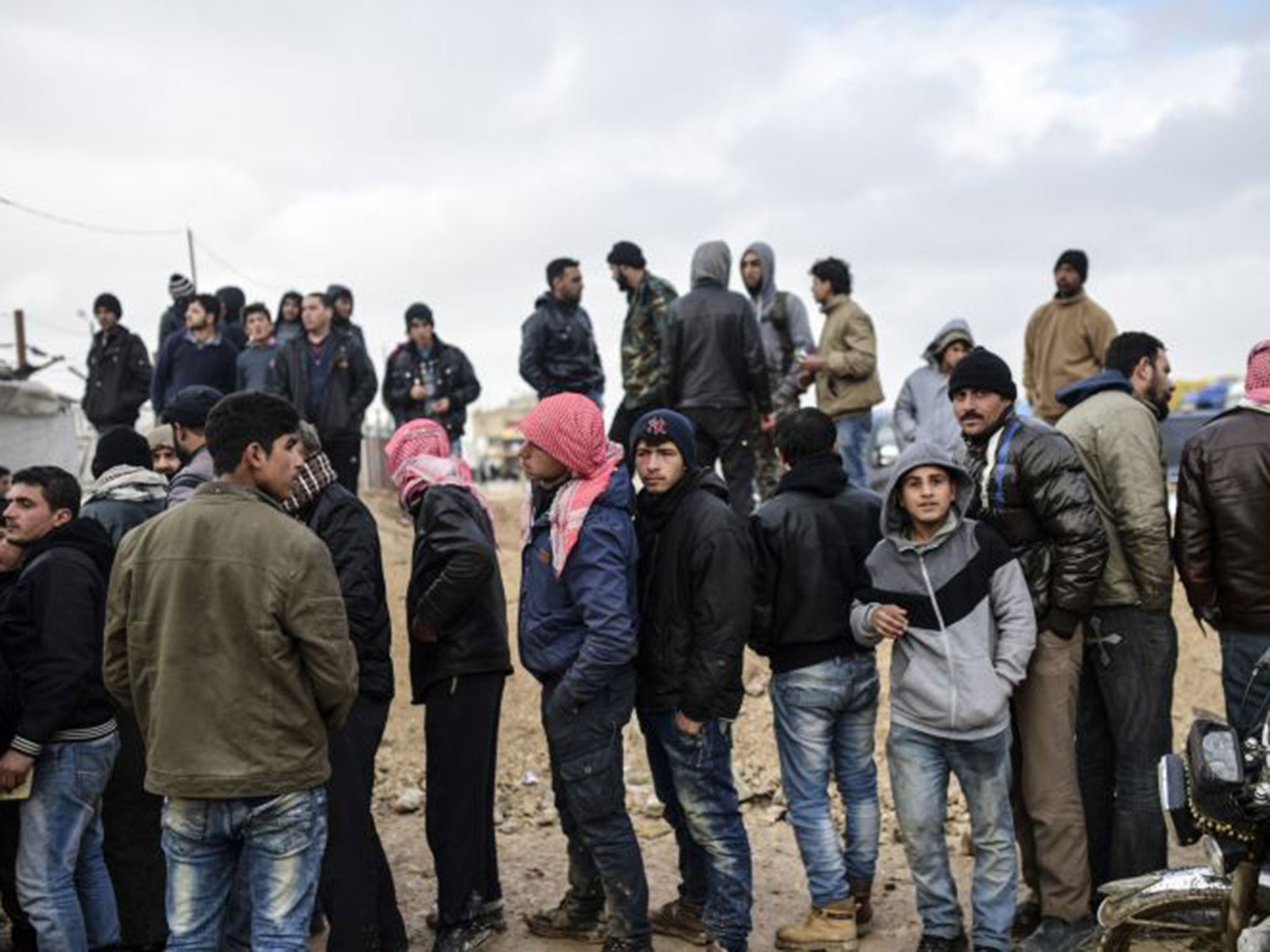 Syrian refugees wait for tents after fleeing the Russian-backed regime attack on the northern city of Aleppo