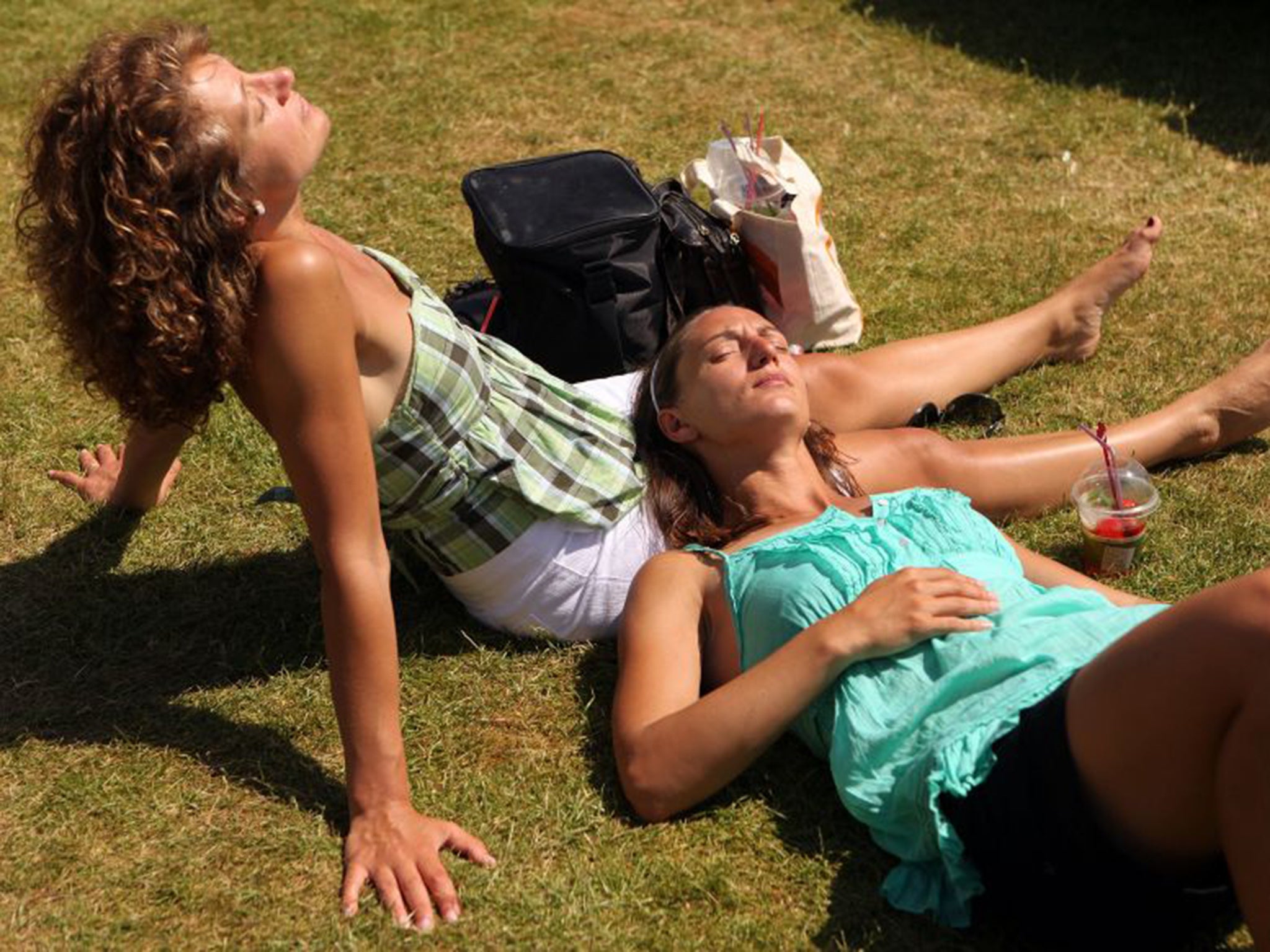 Spectators sunbathe at the Wimbledon Tennis Championships