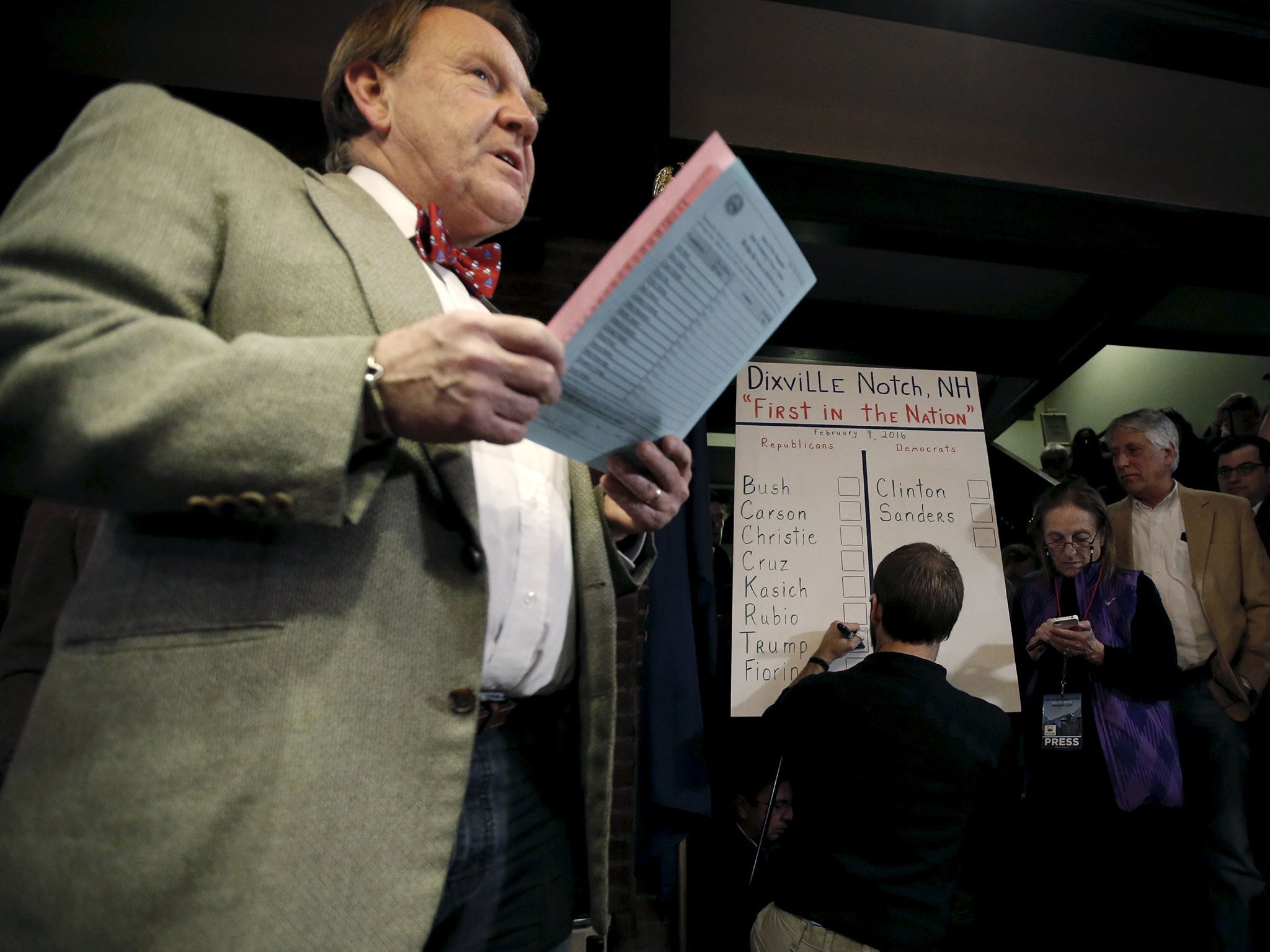 Town moderator Tom Tillotson announces the results of the nine votes cast shortly after midnight