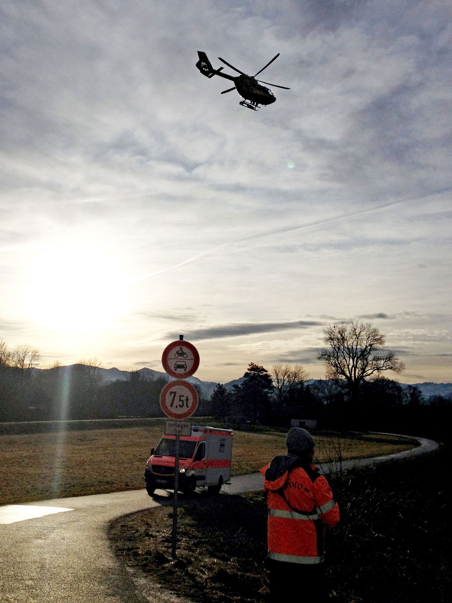 A rescue helicopter flies to the site of the train accident