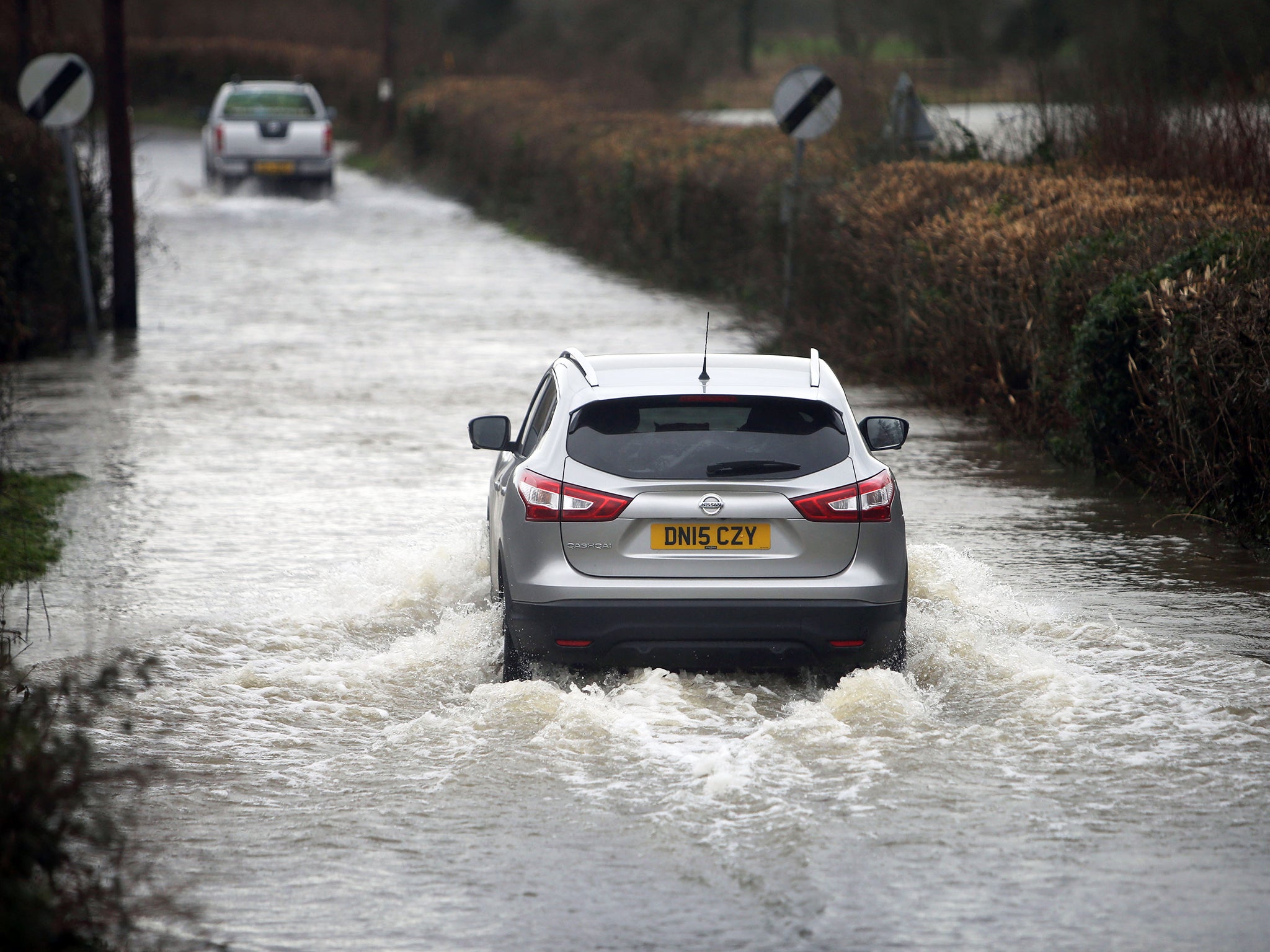 &#13;
Vehicles drive down a flooded road near Lower Brockhampton in Dorset &#13;