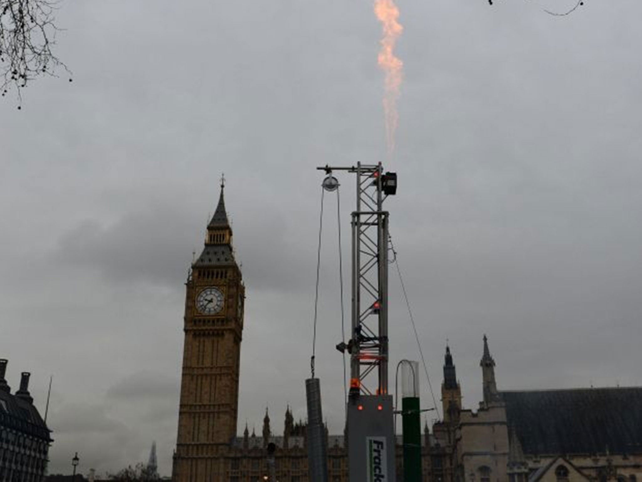 Flames spurt from an imitation fracking rig and drill installed by Greenpeace activists in Parliament Square, central London. The shale-extracting technique could take place near the North York Moors