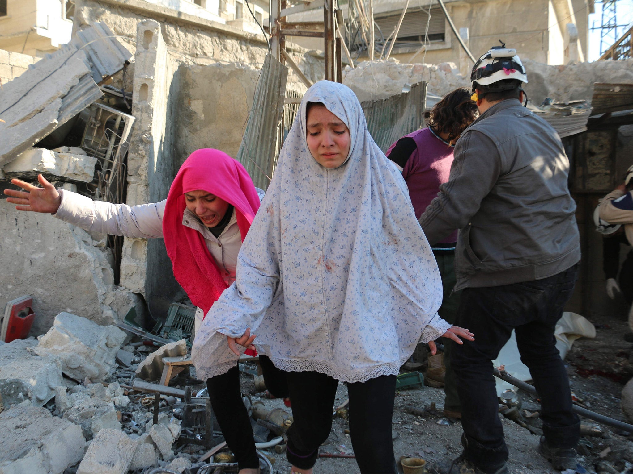 Civilians react following a reported Syrian regime air strike in a rebel-controlled area in Aleppo