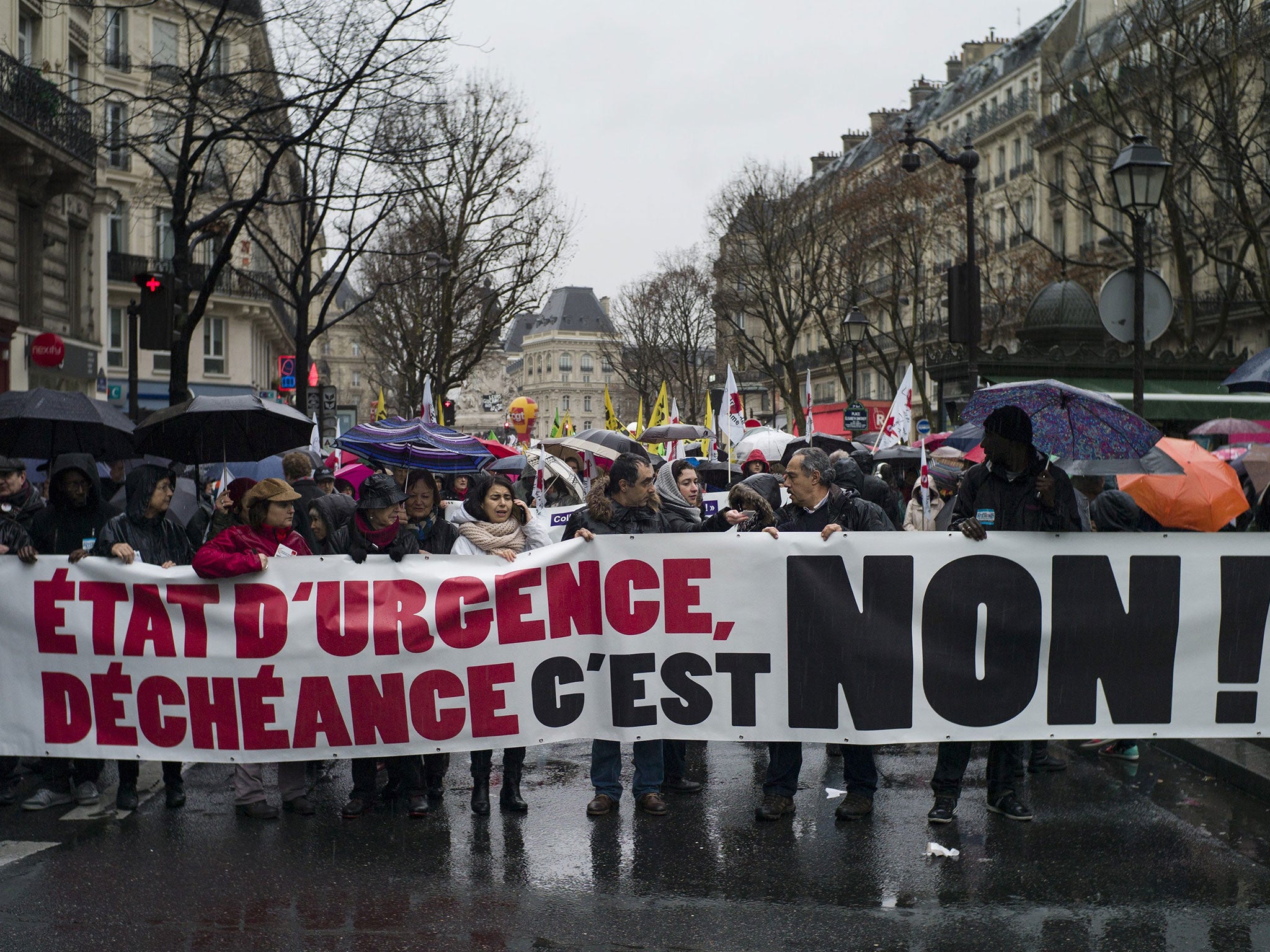 Protesters carry a banner reading: 'State of Emergency, NO to the decline' as thousands demonstrated by the Council of State against the extension by the government of the state of emergency period, in Paris, France, 30 January 2016.