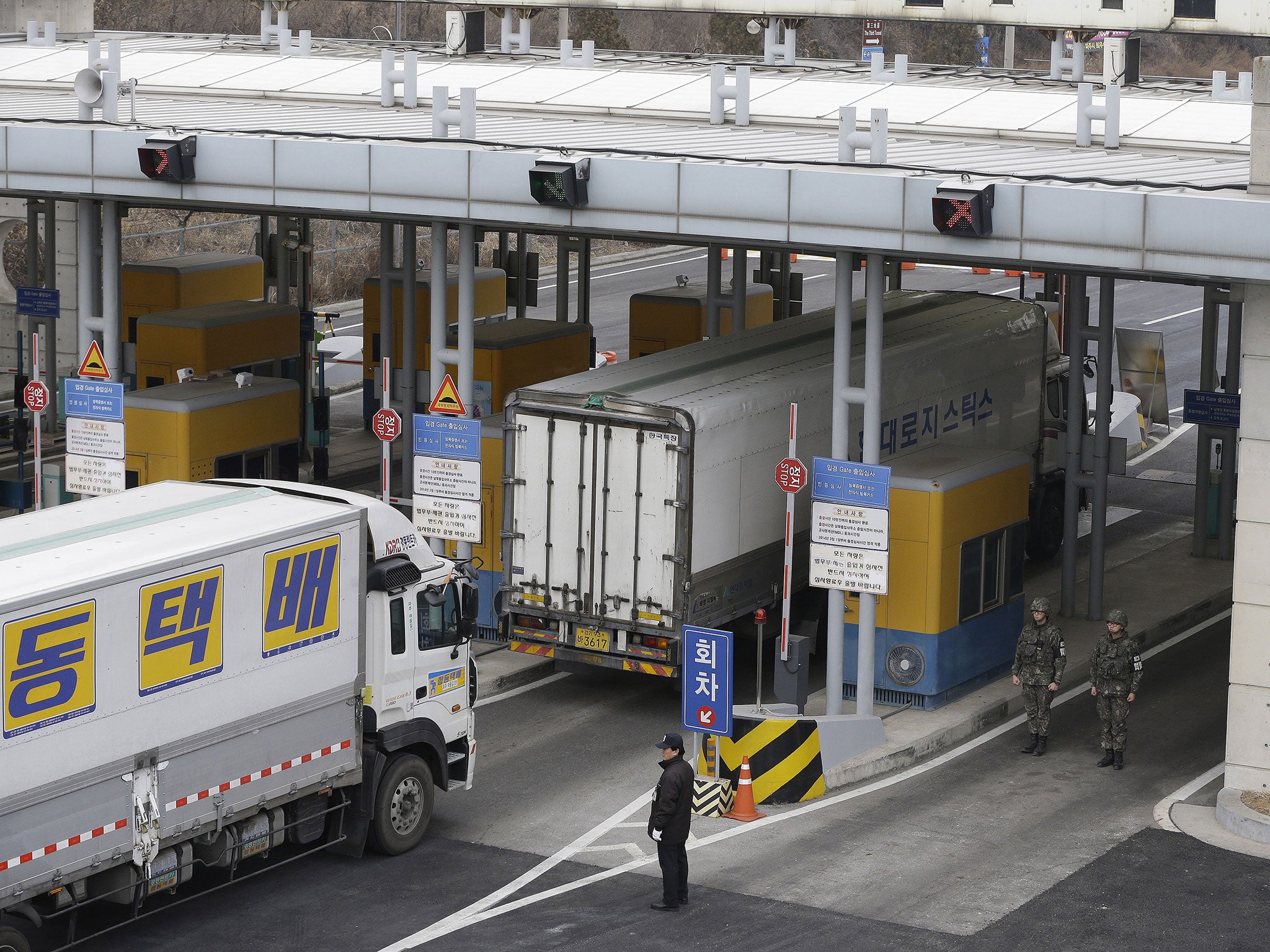 South Korean vehicles returning from North Korea's joint Kaesong Industrial Complex pass the customs, immigration and quarantine office near the border village of Panmunjom in Paju, South Korea, Thursday, Feb. 11, 2016.